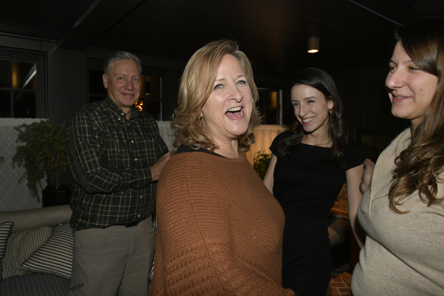 Maria Moore with her family at the Canoe Place Inn early Wednesday morning after the final election results were in. 