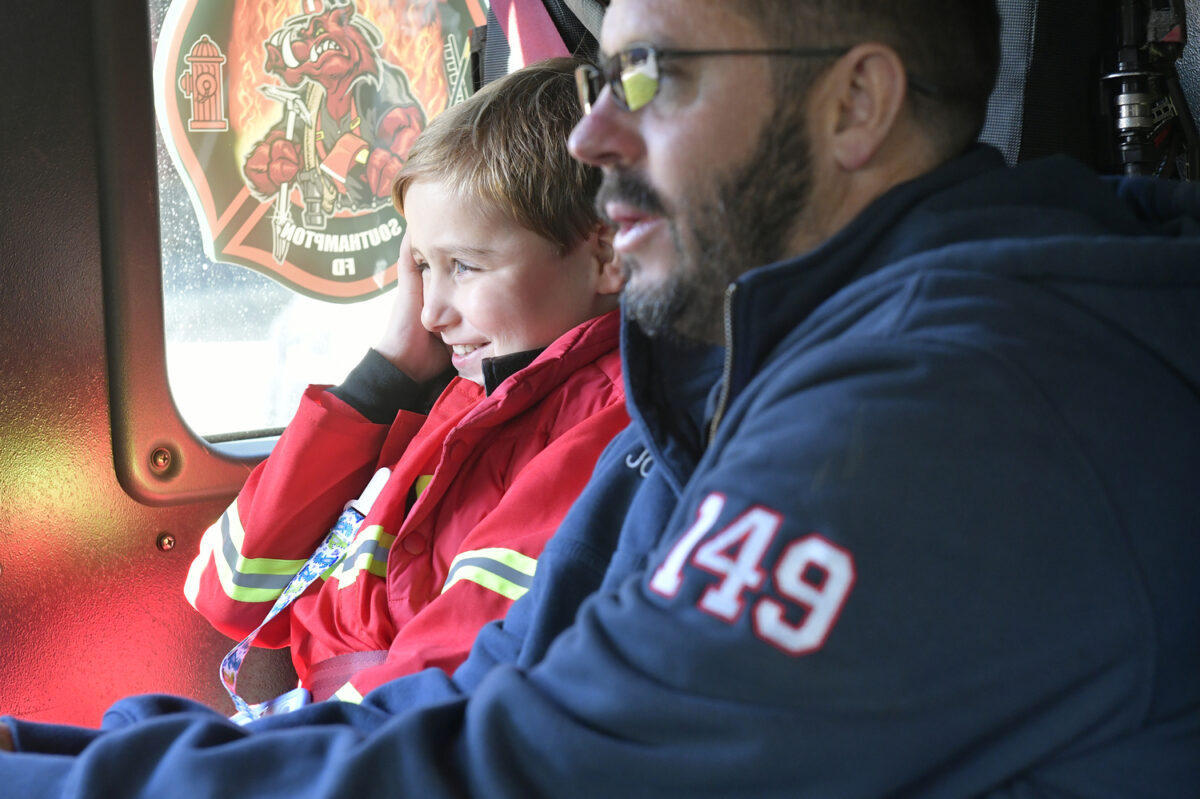 Rowland Egerton-Warburton, with Southampton Agawam Engine firefighter John Parry, getting a ride a fire truck for his birthday on November 15.         DANA SHAW