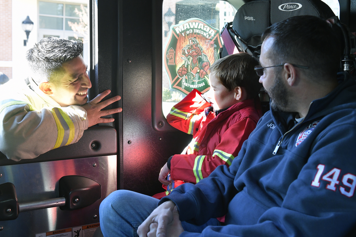 Rowland Egerton-Warburton is greeted by Southampton Fire Department Chief  Manny Ramirez after his ride in the fire truck of his birthday on November 15.   DANA SHAW