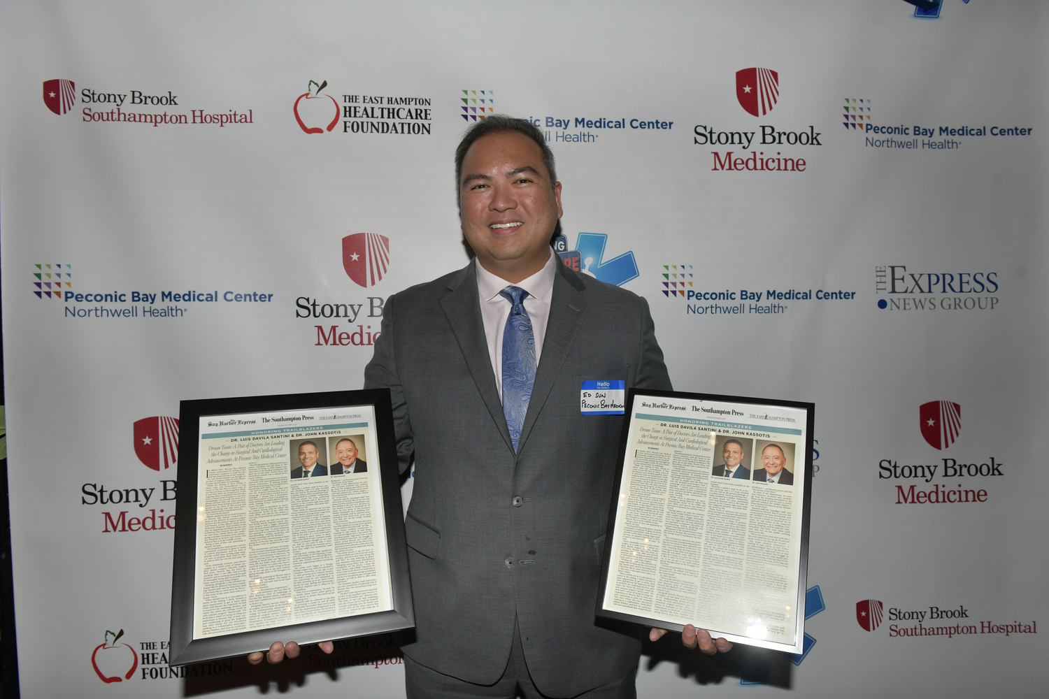 Associate Medical Director of Peconic Bay Medical Center Edward Sun accepts awards for Doctors Luis Davila Santini and John Kassotis.