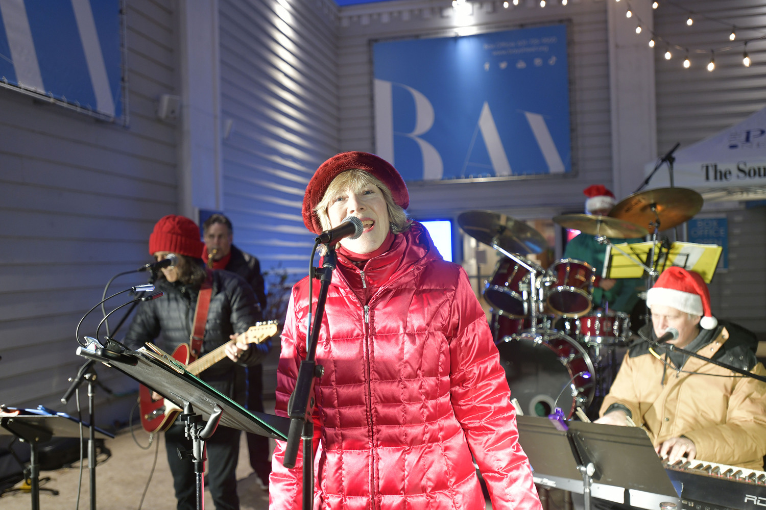 Sarah Conway performs in front of the Bay Street Theater in Sag Harbor for the annual tree lighting on Long Wharf.    DANA SHAW