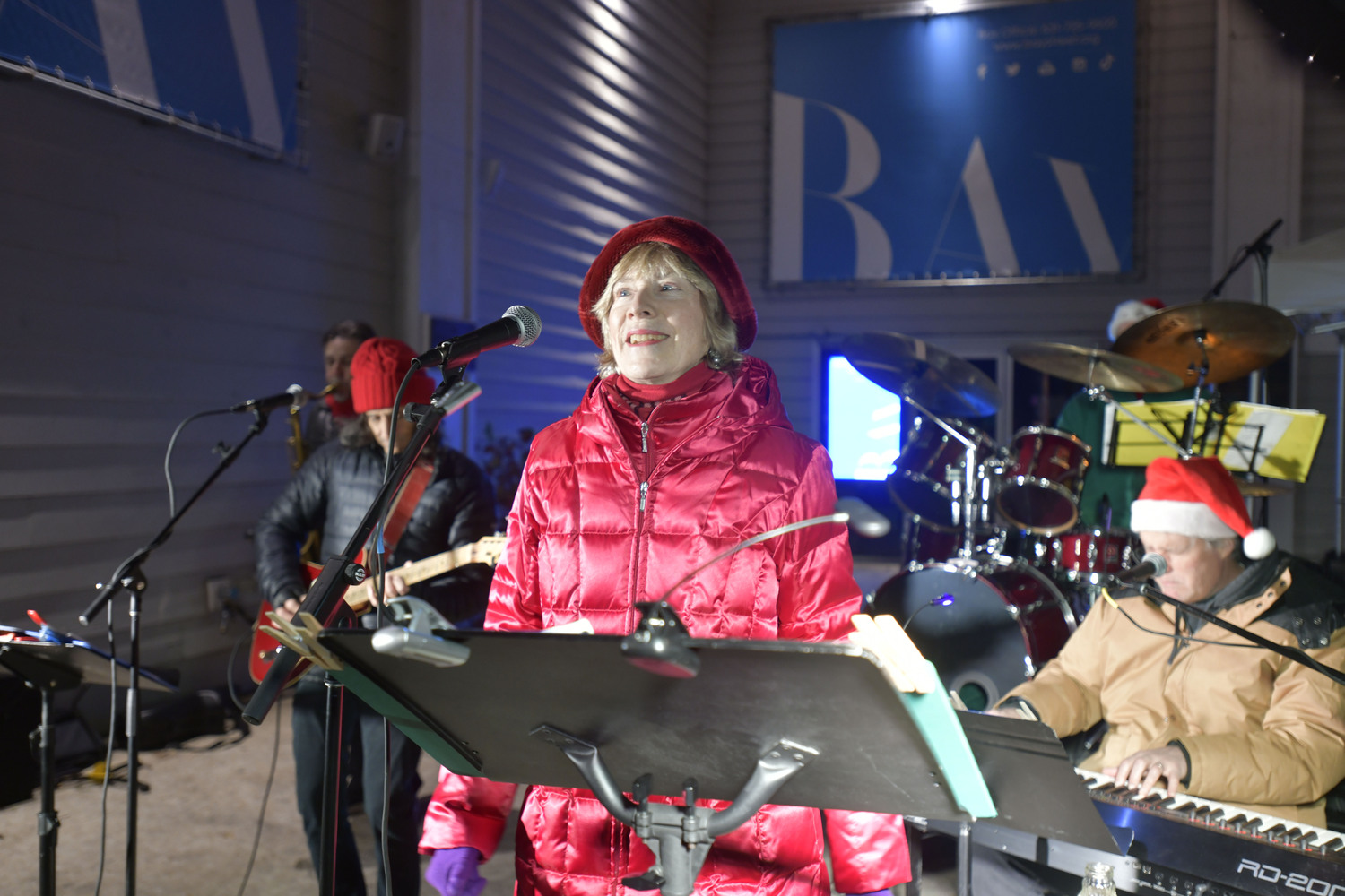 Sarah Conway performs in front of the Bay Street Theater in Sag Harbor for the annual tree lighting on Long Wharf.    DANA SHAW
