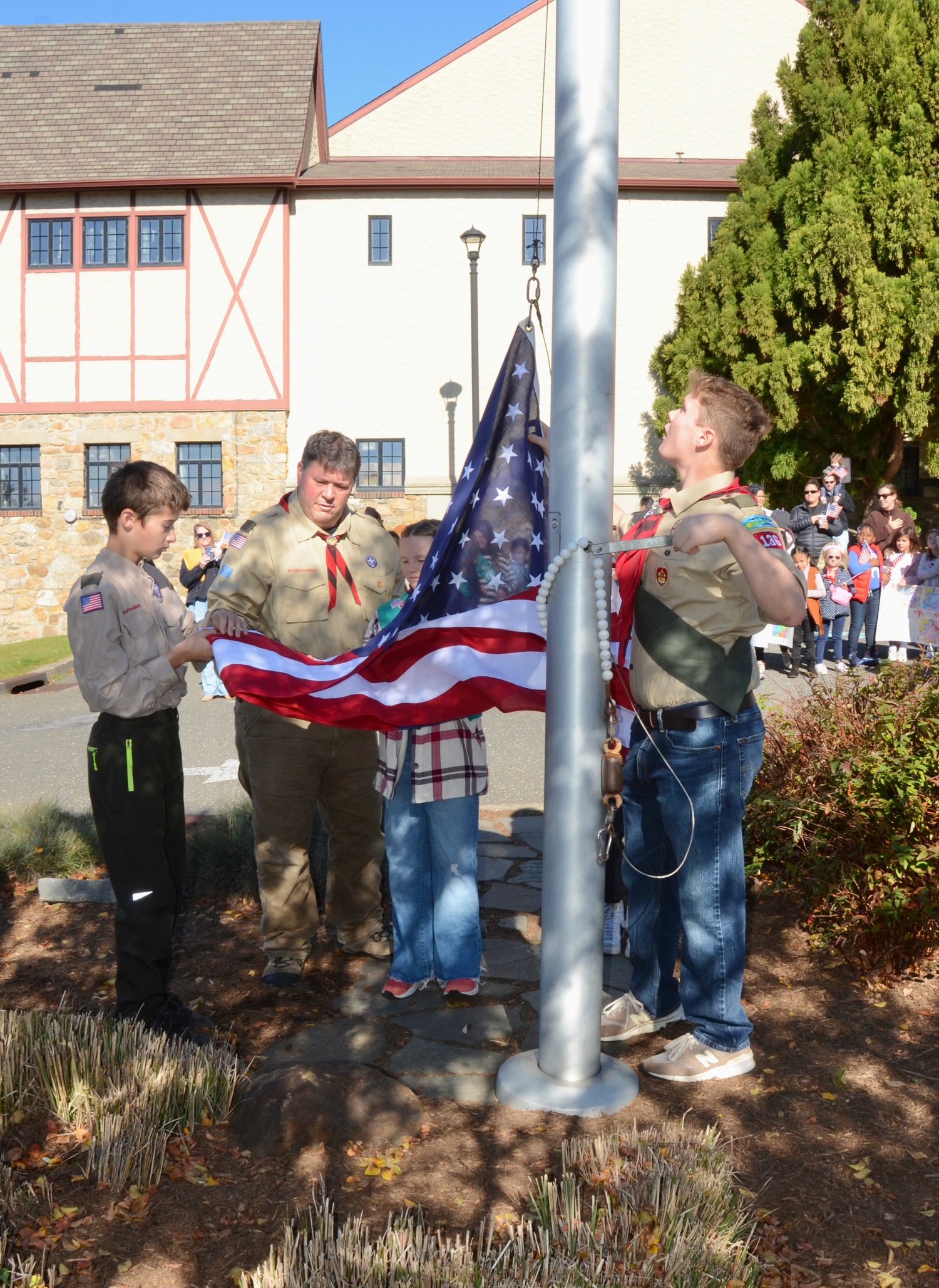 Scouts raise the flag at the The Montauk Playhouse Community Center Foundation's annual Veterans Day Flag Raising Ceremony on Saturday.  KYRIL BROMLEY