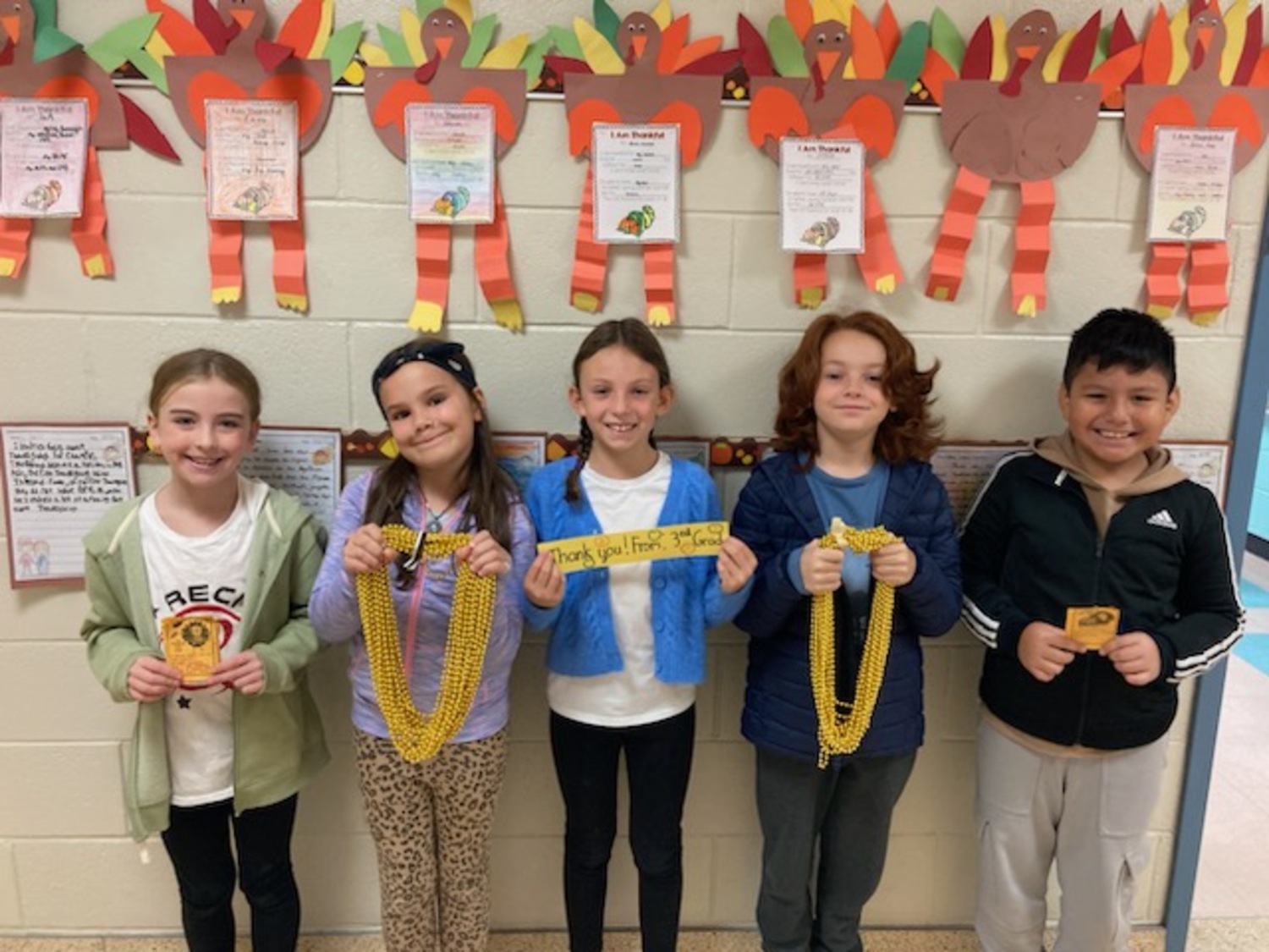 Hampton Bays Elementary School third graders in Jennifer Warren’s class recently hosted a successful fundraiser to help defray the cost of their upcoming trip to the Bronx Zoo. The students raised nearly $800 by selling Gratitude Grams, which contained a friendly message and a golden beaded necklace that they delivered to classrooms throughout their school. COURTESY  HAMPTON BAYS SCHOOL DISTRICT