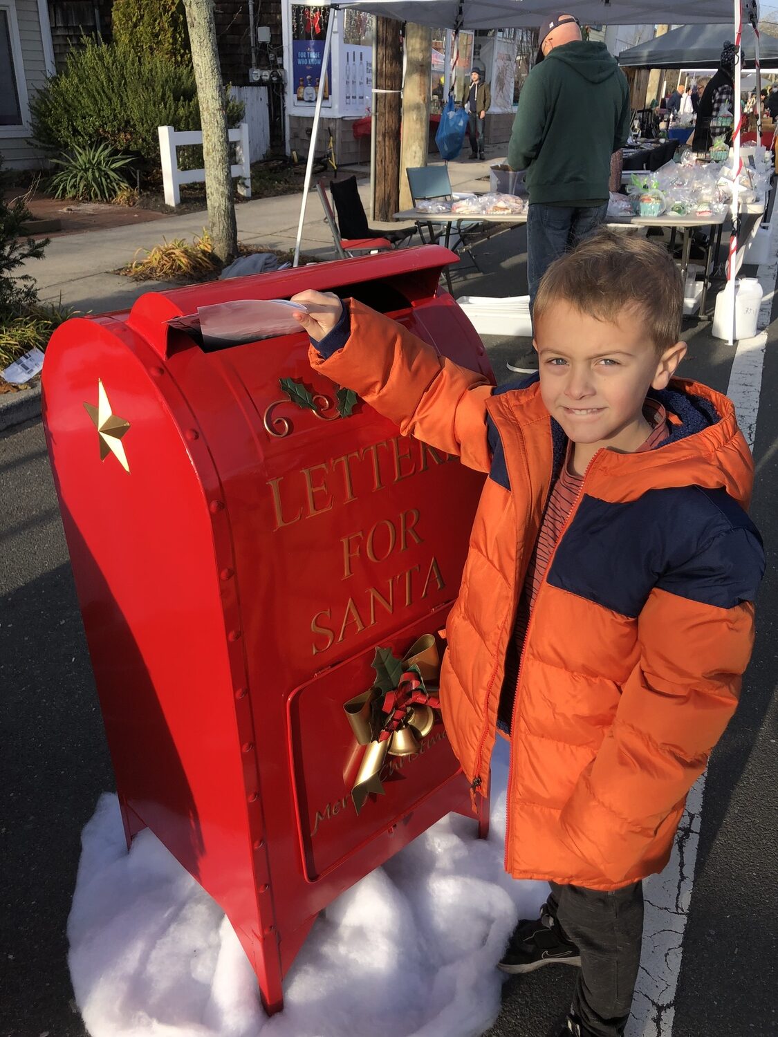 Sebastian Riley puts her letter to Santa in a special mailbox at 