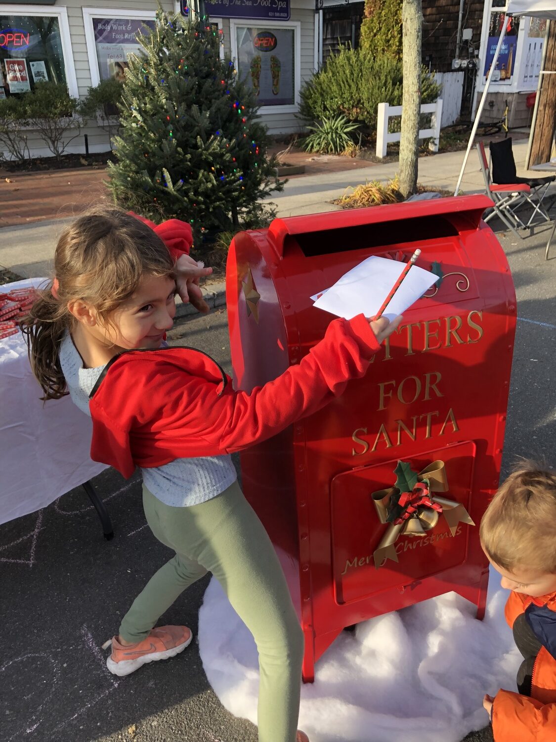 Claire Riley puts her letter to Santa in a special mailbox at 