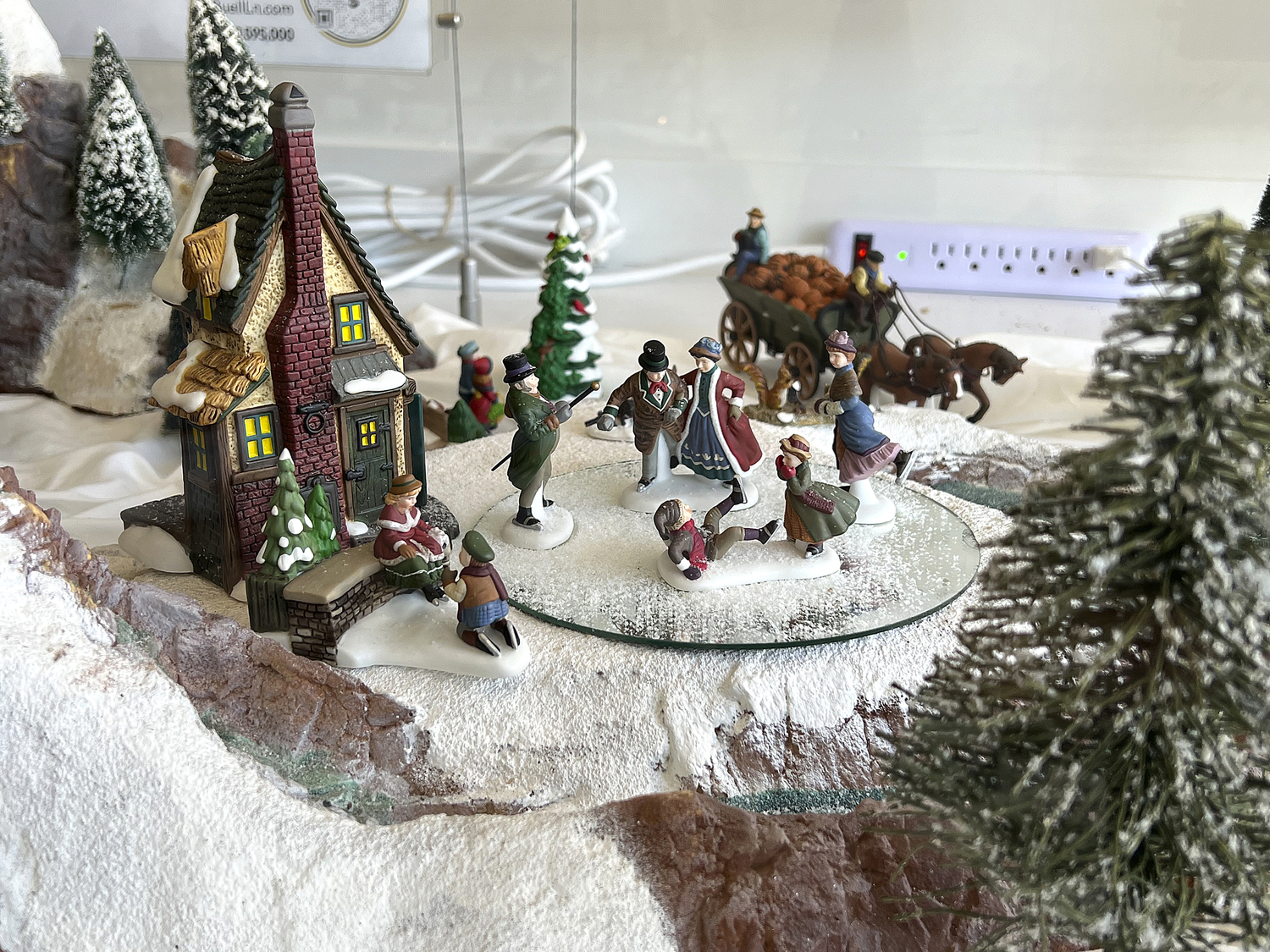 A vignette of Jane Holden's Christmas Village in the Brown Harris Stevens window in Sag Harbor.   DANA SHAW