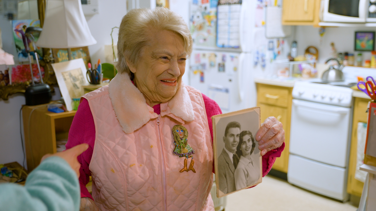 Judy Sleed holds a photo with her husband during production of the documentary 