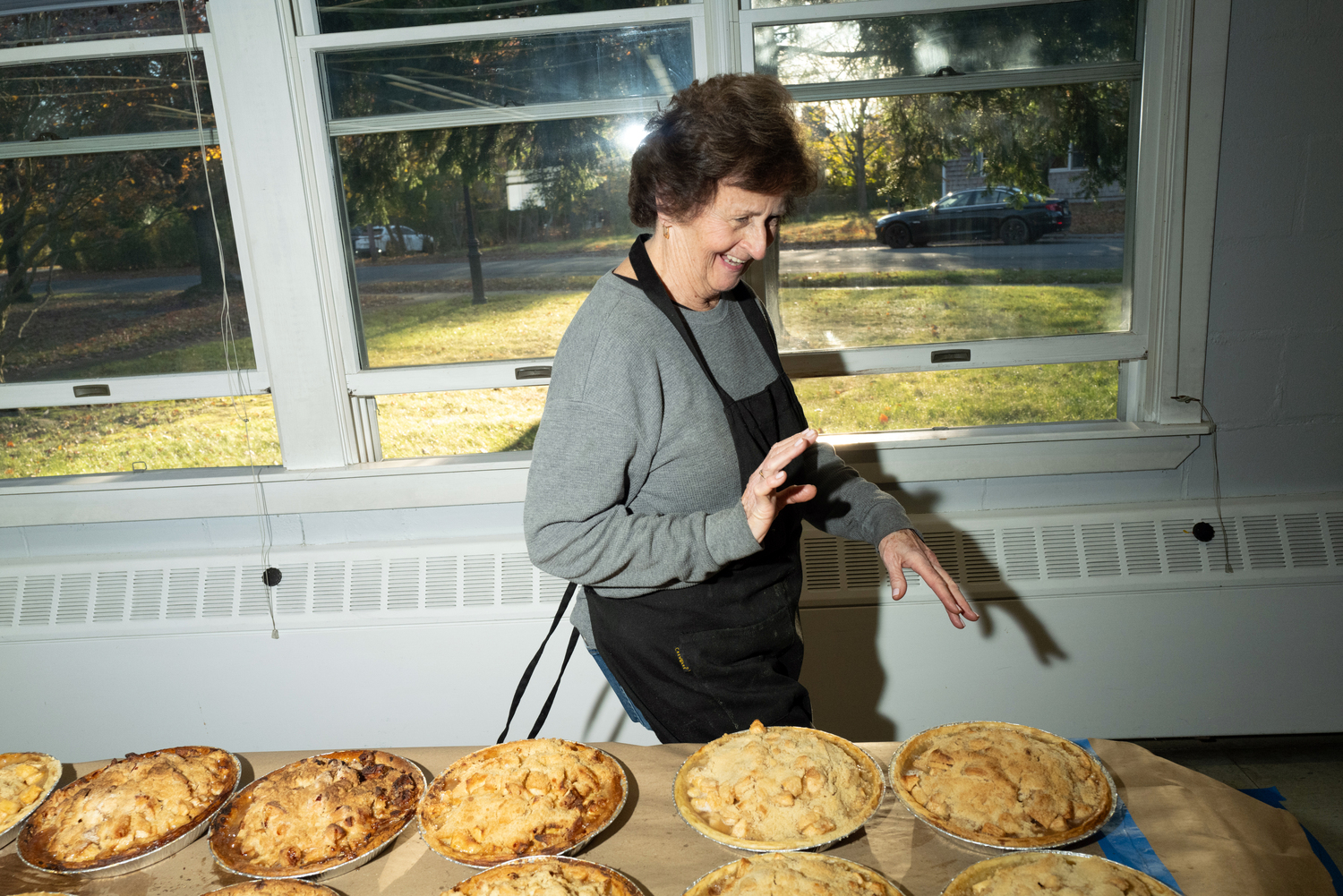 Betsy Remkus checks on the cooling pies.  LORI HAWKINS