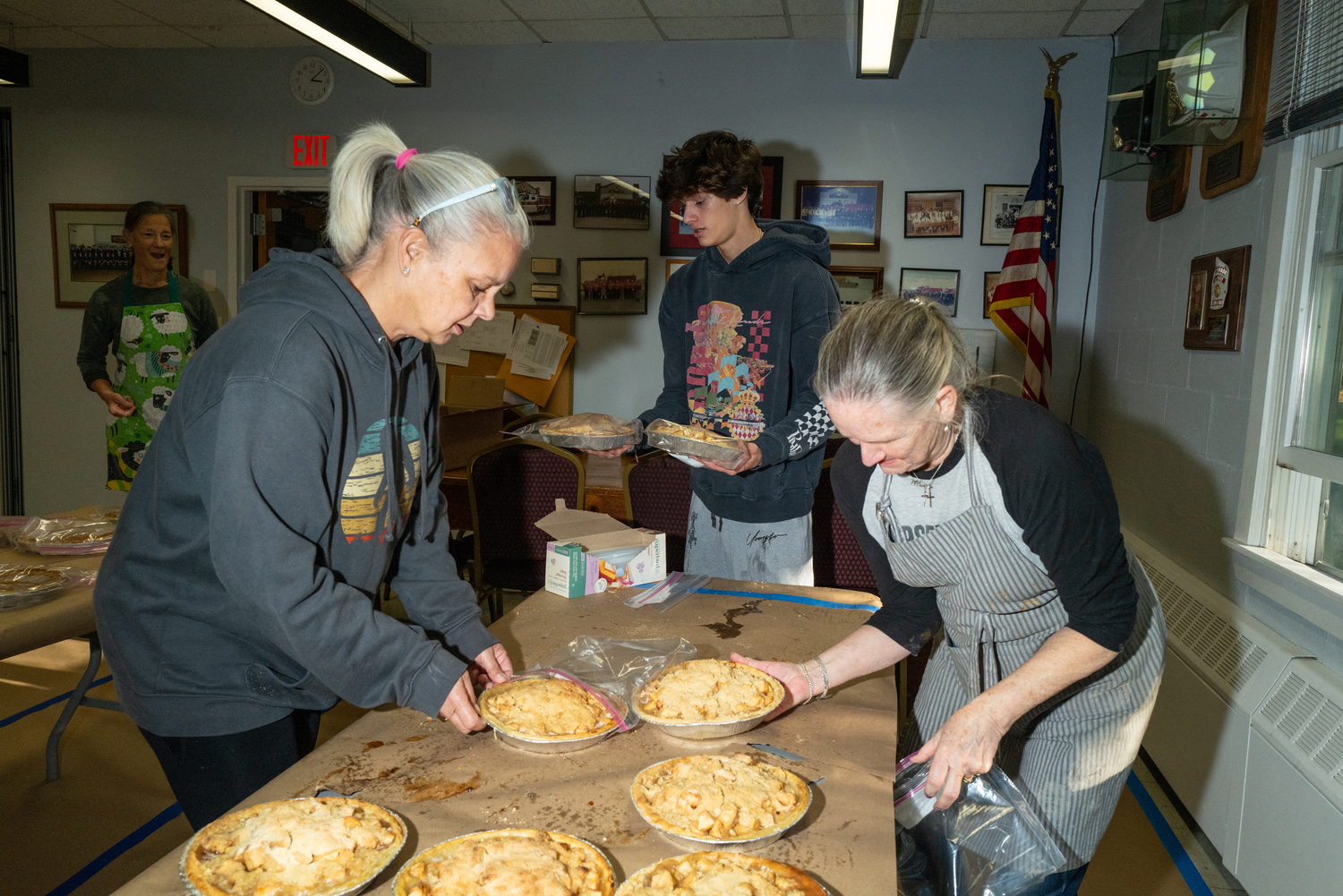 Marie Schellinger, Mario Cuomo, and Rhodi Winchell pack up pies for delivery. LORI HAWKINS