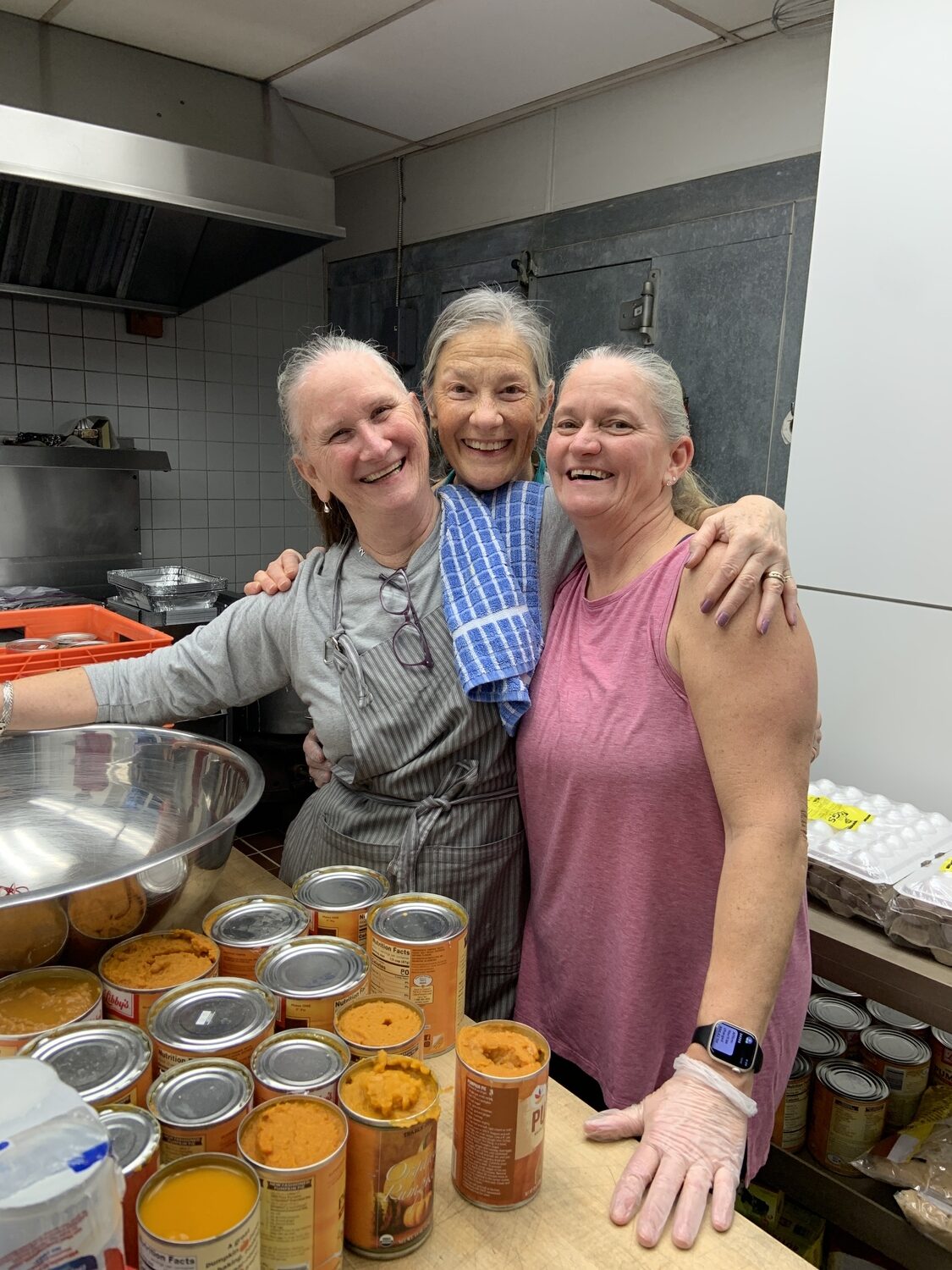 Rhodi Winchell, from left, Cheryl Rozzi, and Fran Nill midway through the first day's preparation and baking. STEPHEN J. KOTZ