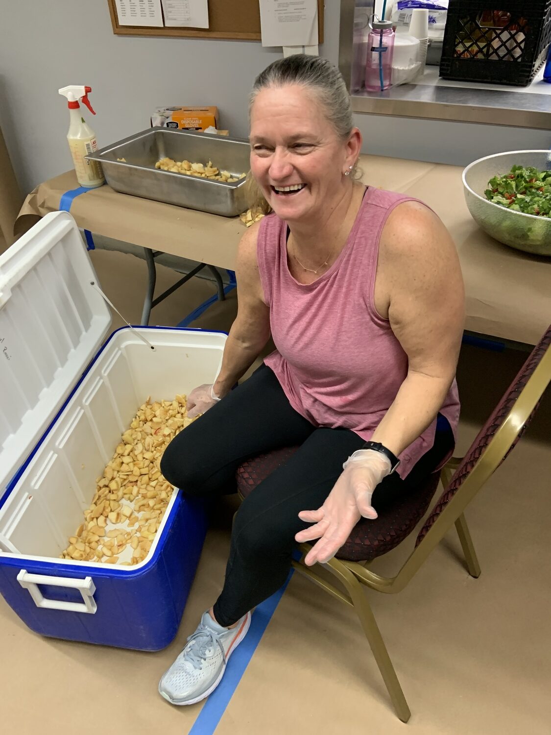 Fran Bill with a small portion of the peeled apples that went into the pie-baking operation. STEPHEN J. KOTZ
