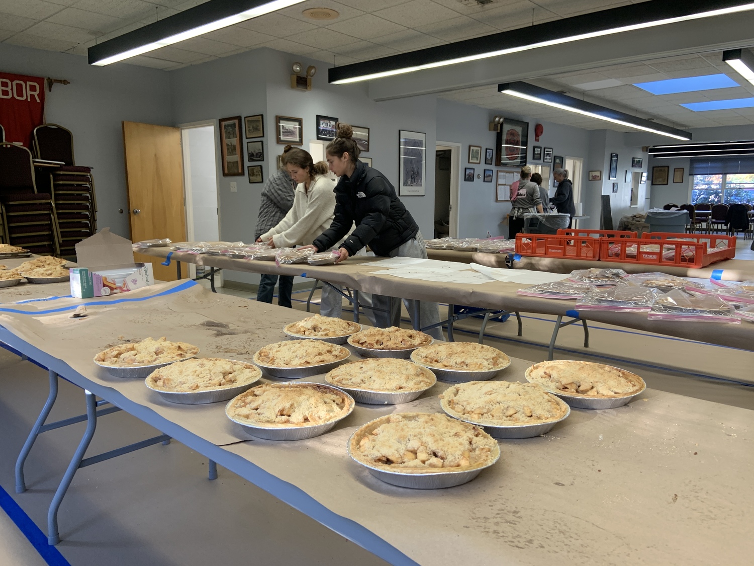 Volunteers lay out pies to cool after a marathon baking session on Saturday. STEPHEN J. KOTZ