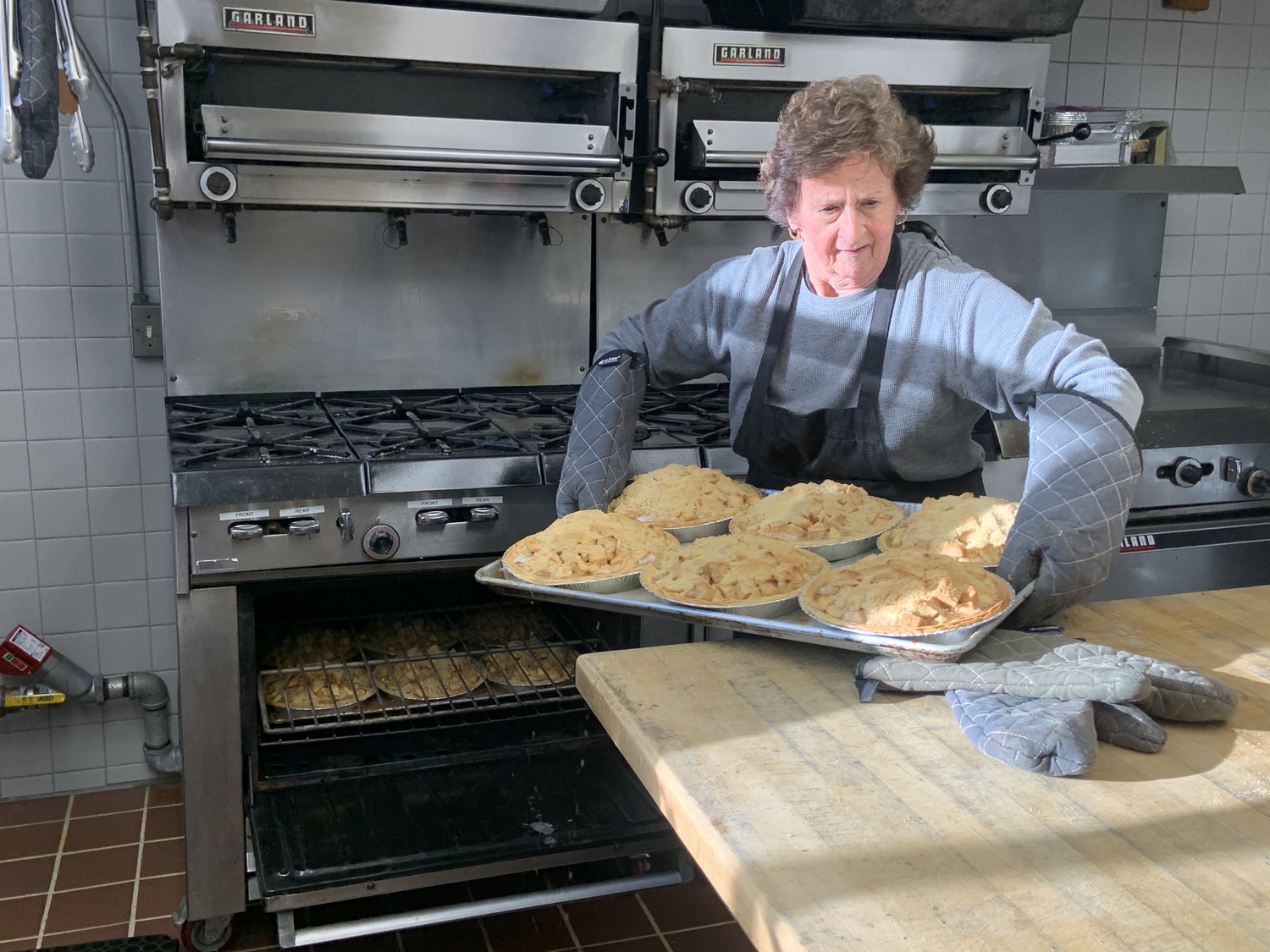 Betsy Remkus with a load of just-baked apple crumb pies. STEPHEN J. KOTZ
