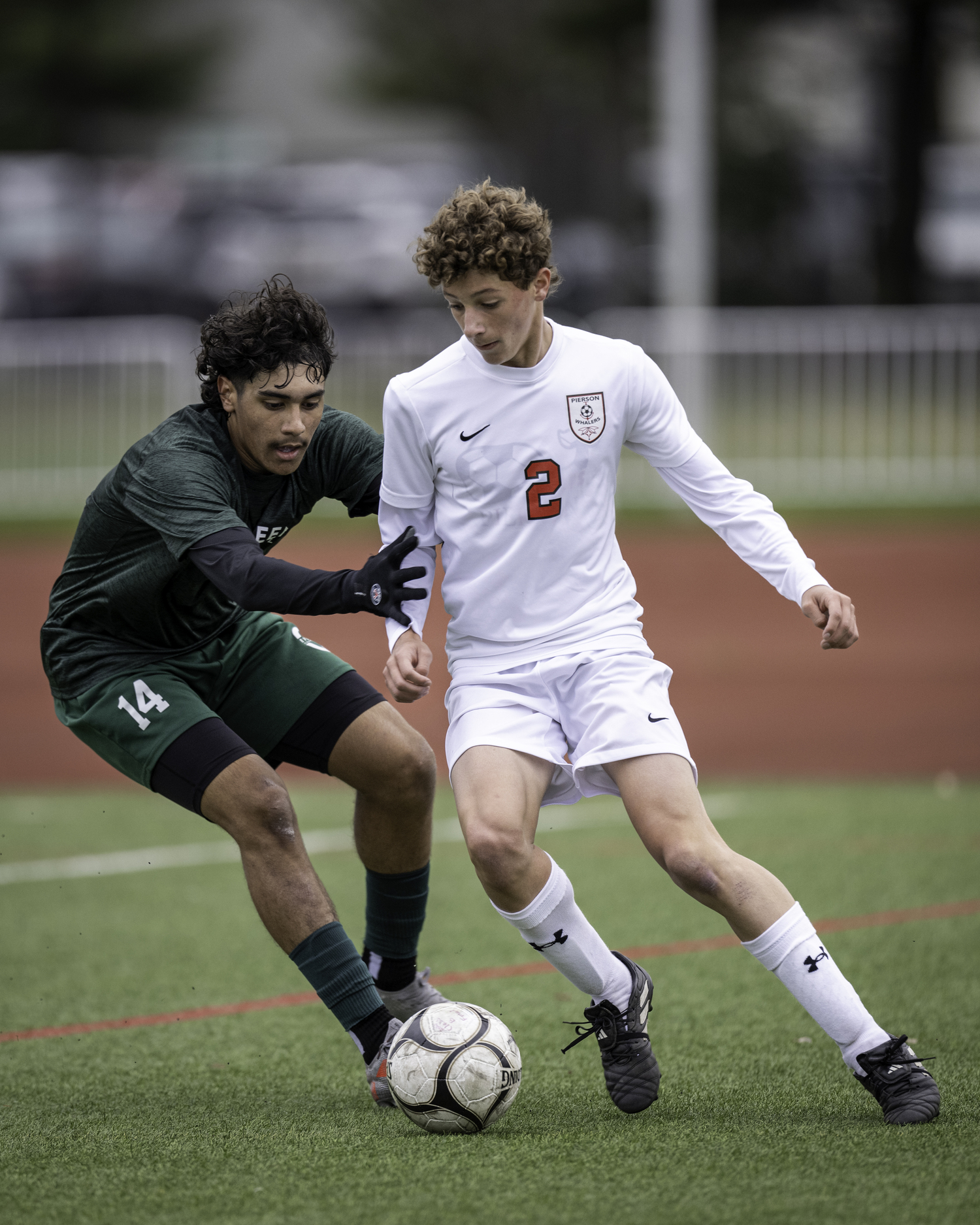 Pierson junior Andy Wayne plays the ball with an Evergreen Charter player on his back.   MARANNE BARNETT