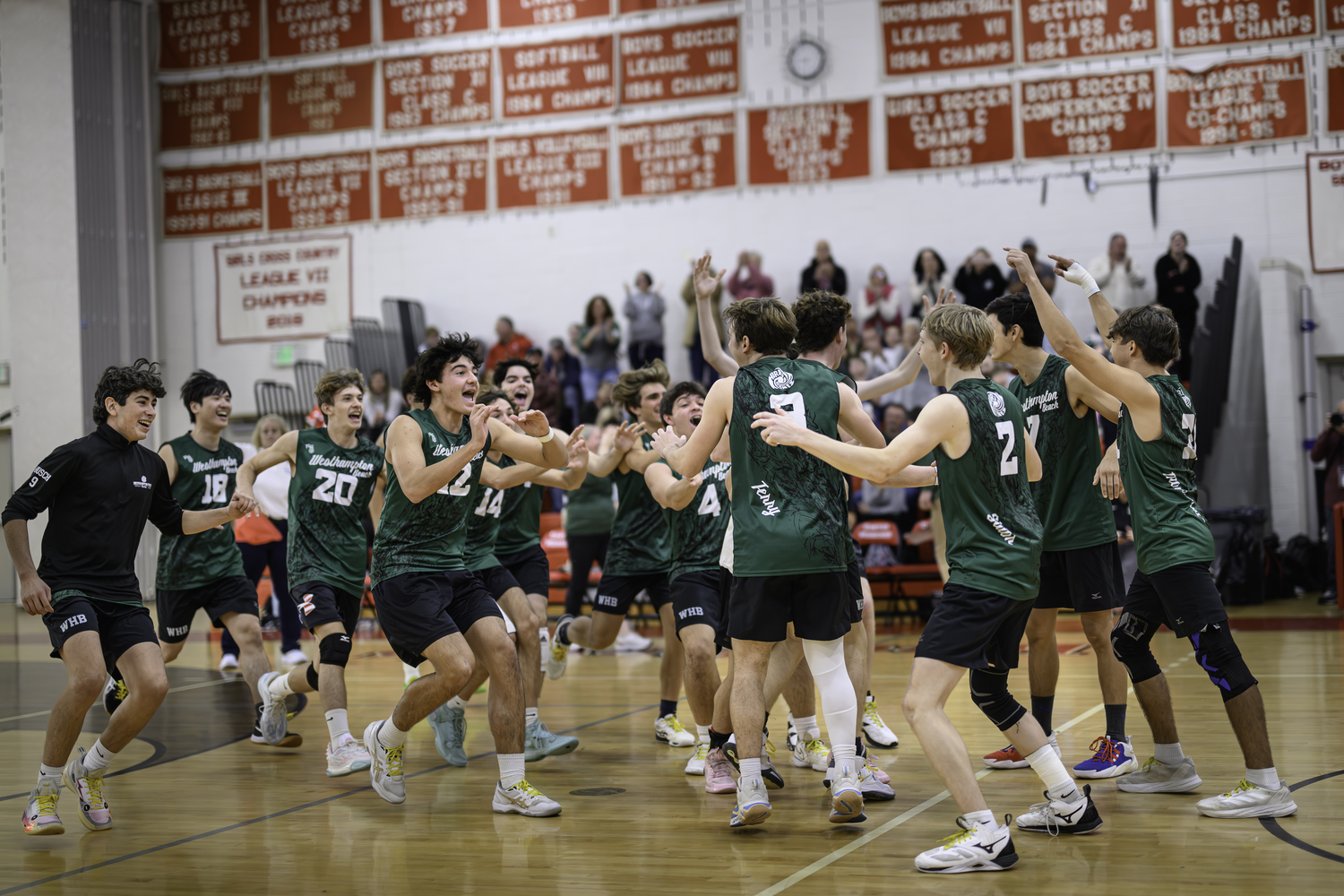 Westhampton Beach's boys volleyball team storms the court following the Hurricanes' second Division II Long Island Championship win. MARIANNE BARNETT