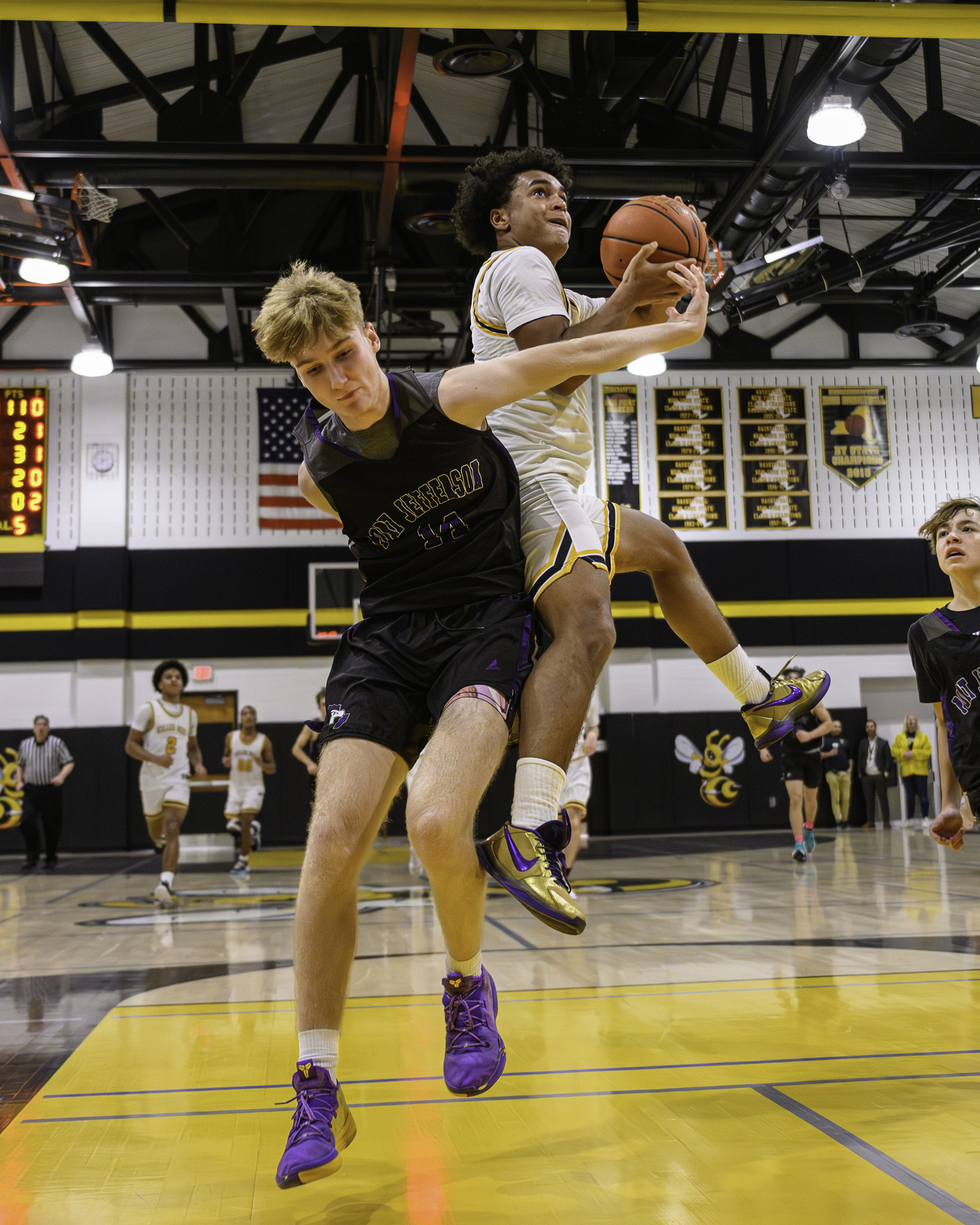 Alex Davis absorbs contact from Tyler Cobb as he goes up for a layup.   MARIANNE BARNETT