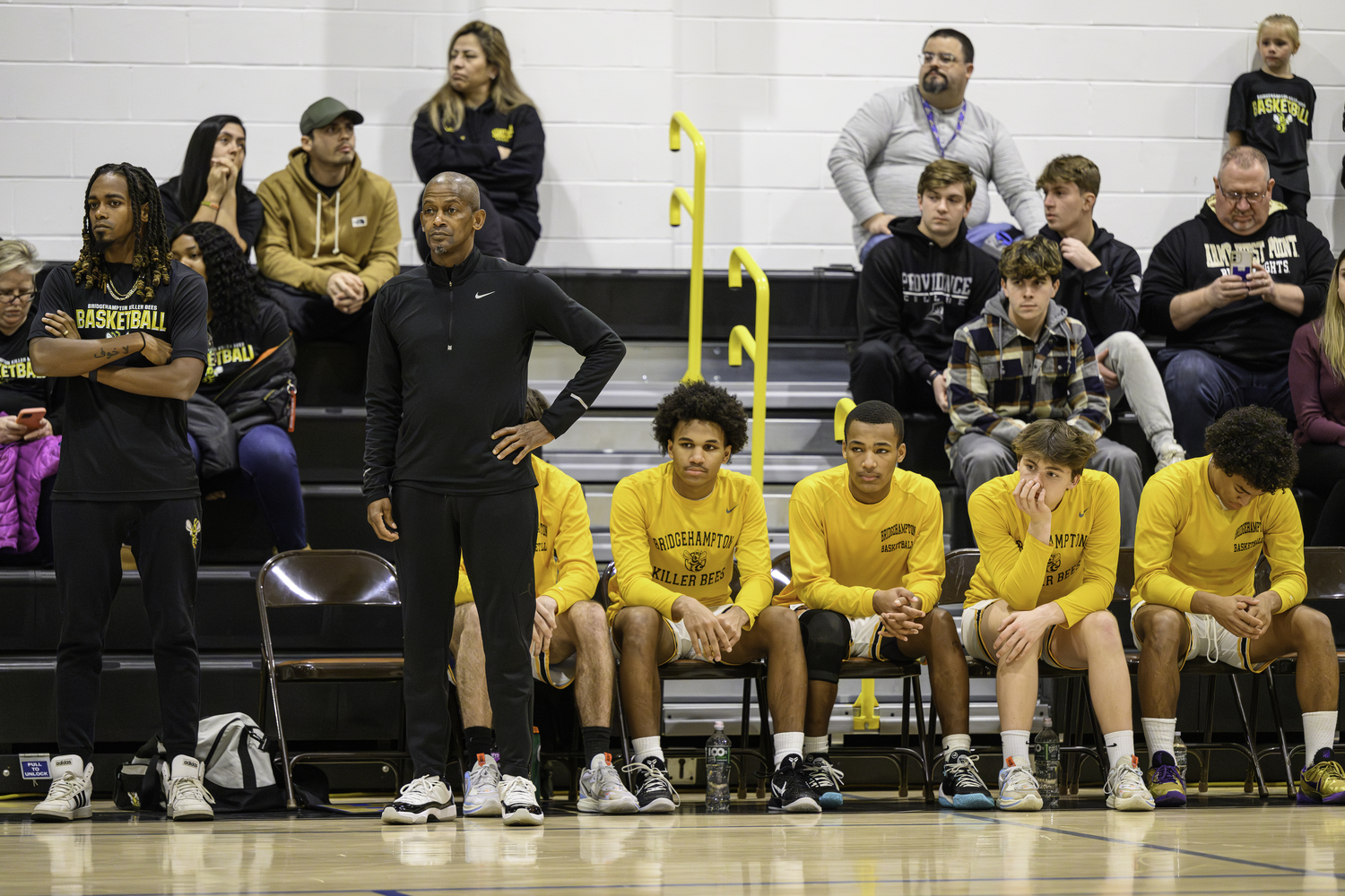 Carl Johnson, with his son and assistant coach Davin Johnson, watch their team during the first few minutes of last week's home opener.   MARIANNE BARNETT