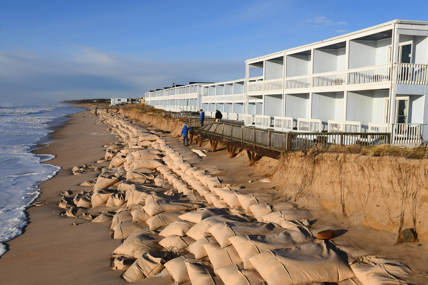 The sand bag revetment along downtown Montauk was battered by Monday's storm, which hit at high tide with tropical storm force winds and waves over 25 feet high. DOUG KUNTZ