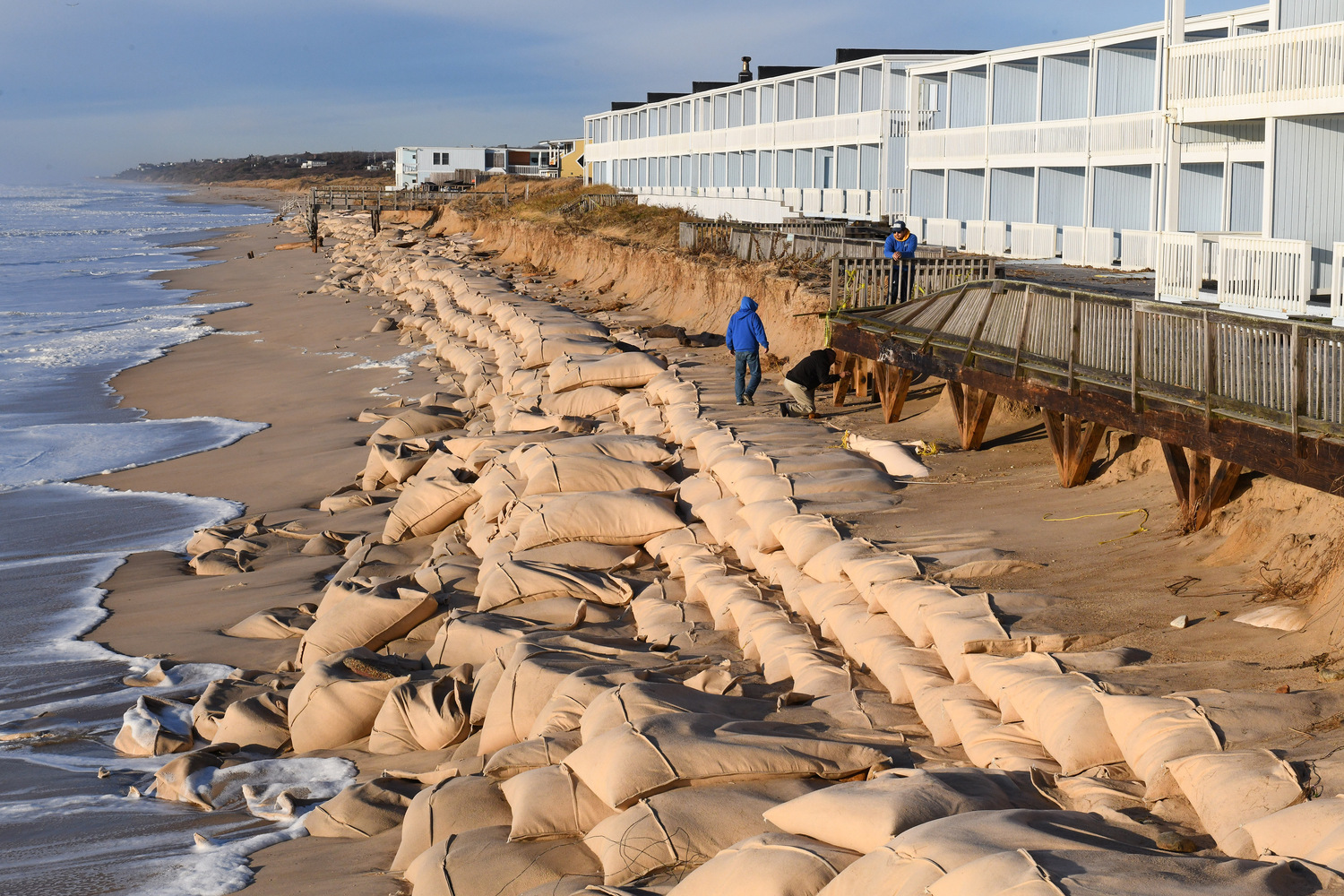 The sand bag revetment along downtown Montauk was battered by Monday's storm, which hit at high tide with tropical storm force winds and waves over 25 feet high. DOUG KUNTZ