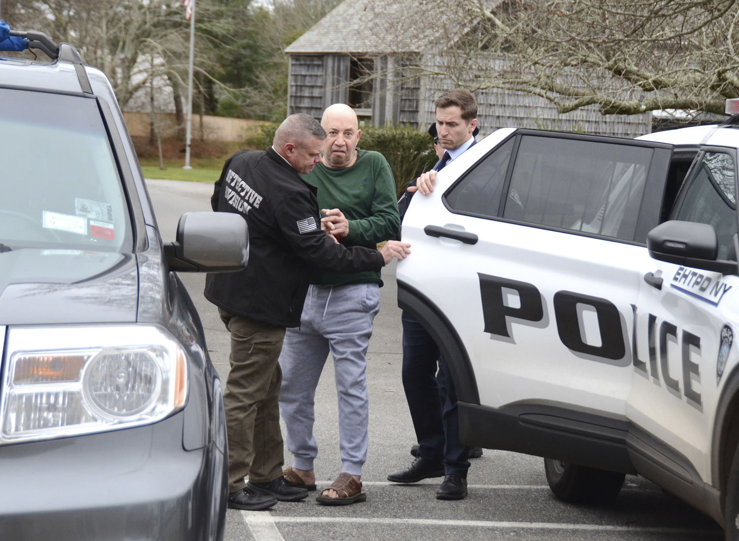 Michael Nicholoulias, 74, of East Hampton is led to his arraignment in East Hampton Town Justice Court on Tuesday afternoon.  KYRIL BROMLEY