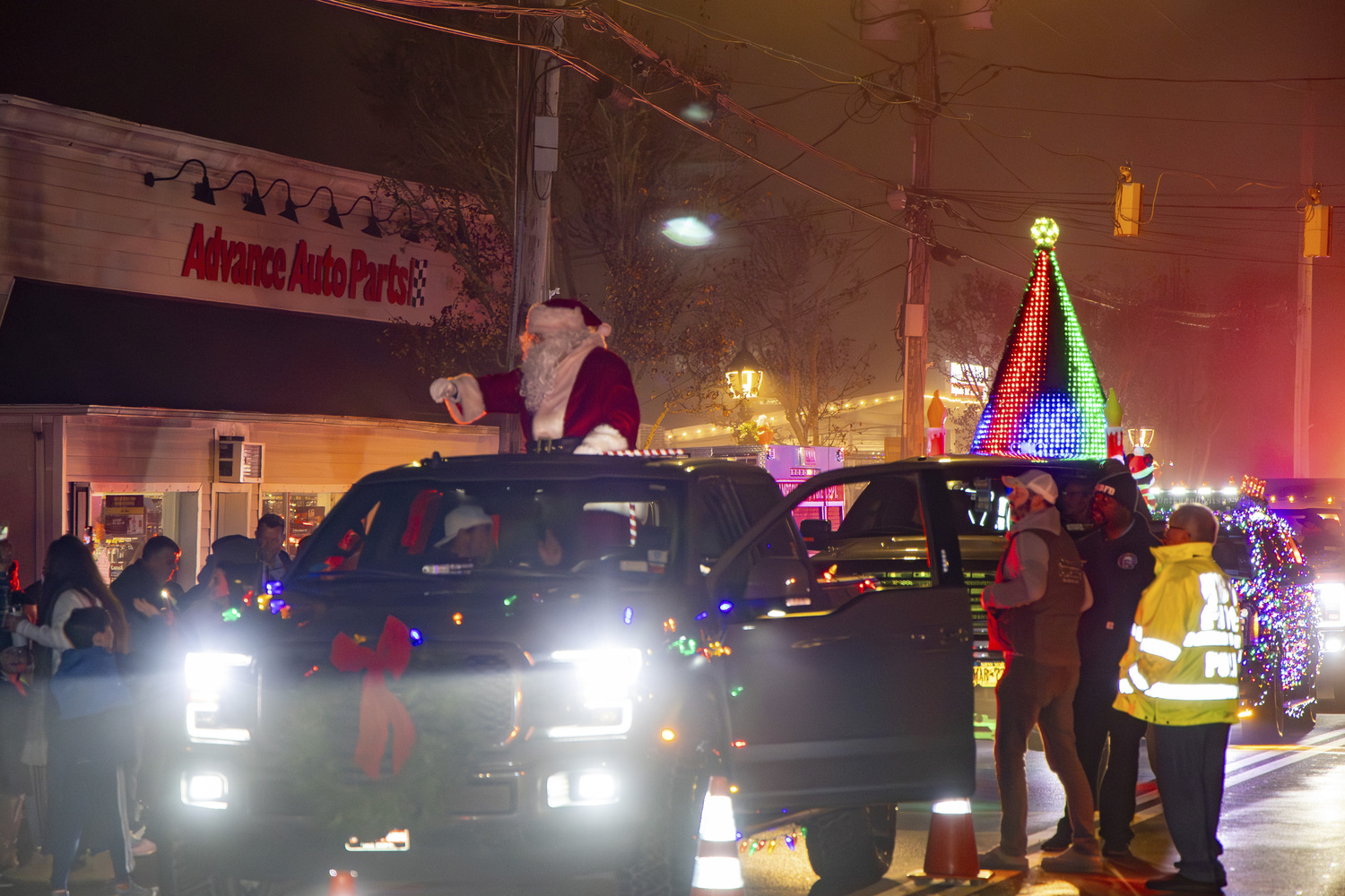 Santa arrived at the Hampton Bays firehouse after a parade through town on Saturday carolers performed and the tree was lighted.   MICHAEL O'CONNOR