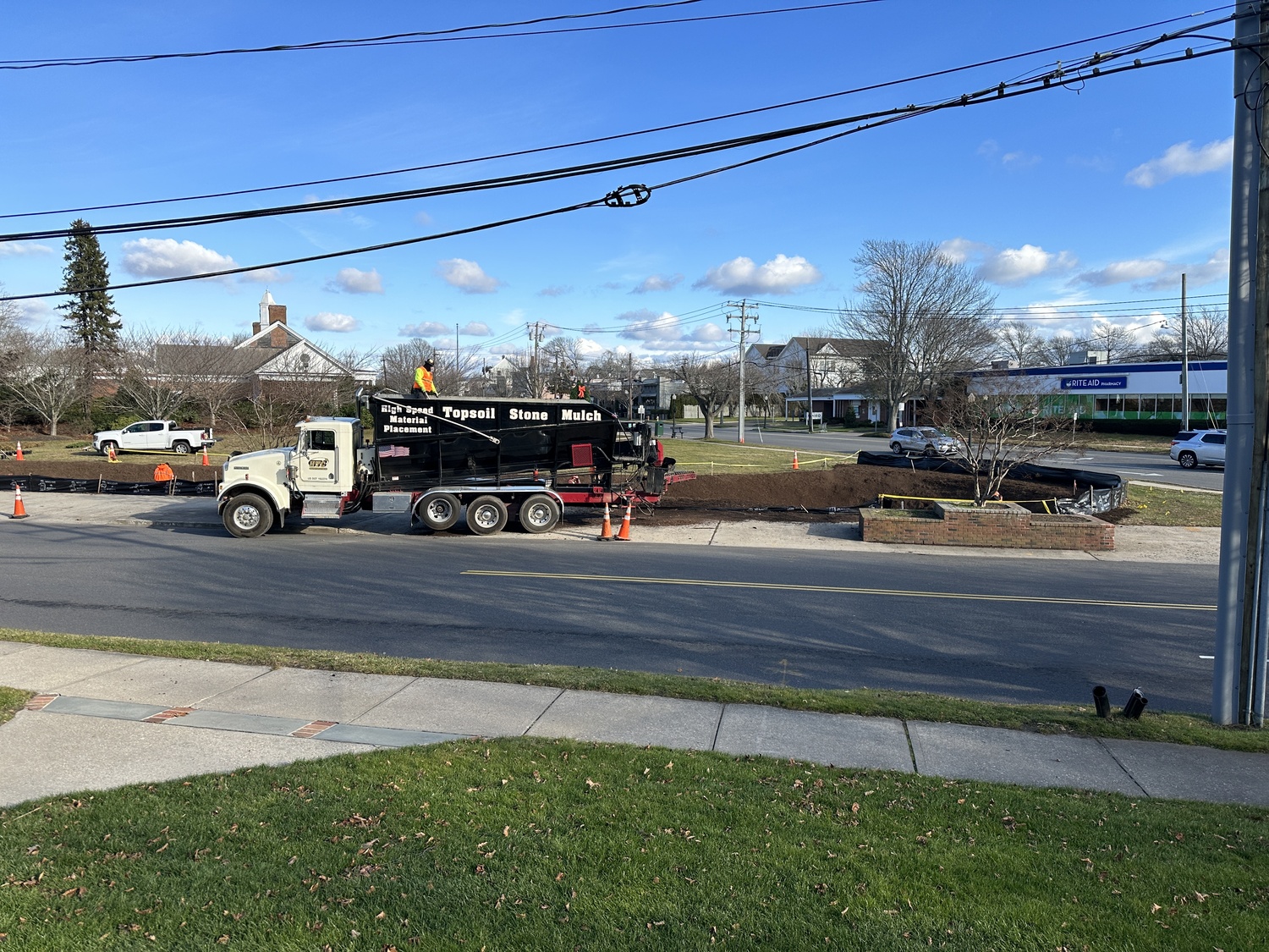 The newly installed bioswale at the corner of Windmill Road and Nugent Street will help filter stormwater and protect Lake Agawam. BRENDAN O'REILLY
