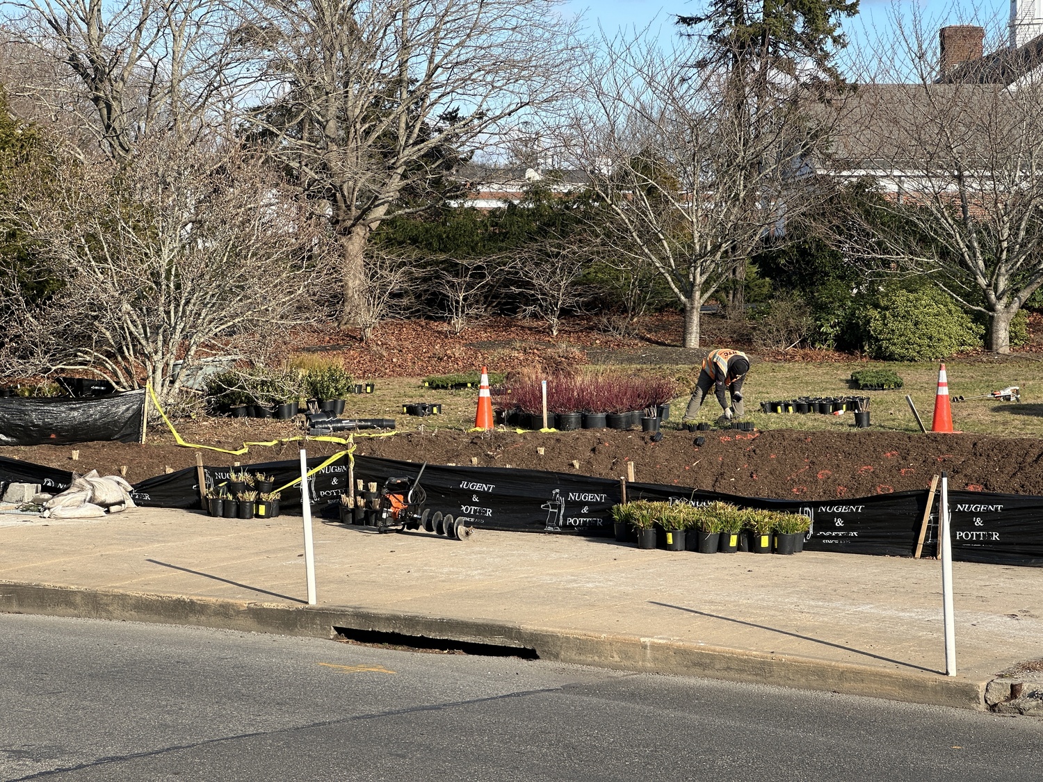 The newly installed bioswale at the corner of Windmill Road and Nugent Street will help filter stormwater and protect Lake Agawam. BRENDAN O'REILLY