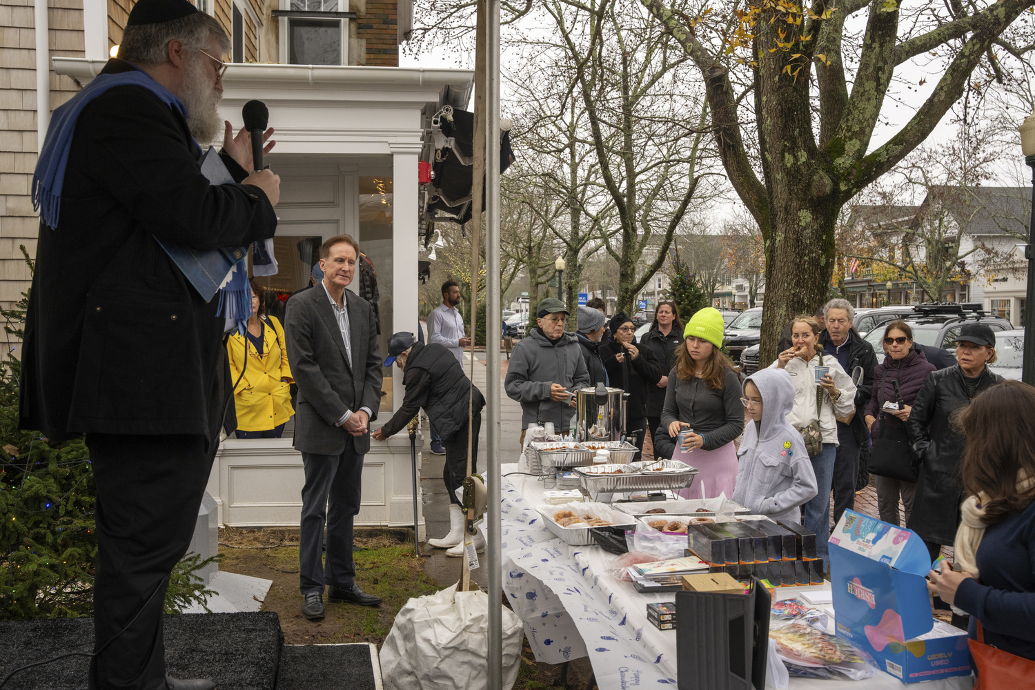 Rabbi Rafe Konikov of the Chabad of Southampton Jewish Center welcomes the crowd to the lighting of the menorah at the Southampton Chamber of Commerce on Sunday.   RON ESPOSITO