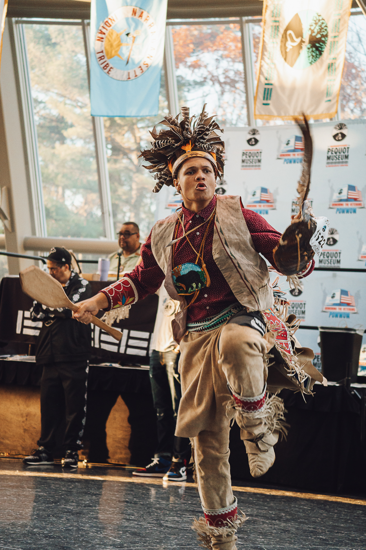 Nootimus Williams participates in the Eastern War Dance during the Veteran’s Day Powwow at the Pequot Museum. The dance represents one of two stories: a man going to war, or a man going to hunt. Williams wears a gustoweh made of turkey feathers, a hunter-style regalia that blends in with nature. REBEKAH PHOENIX WISE