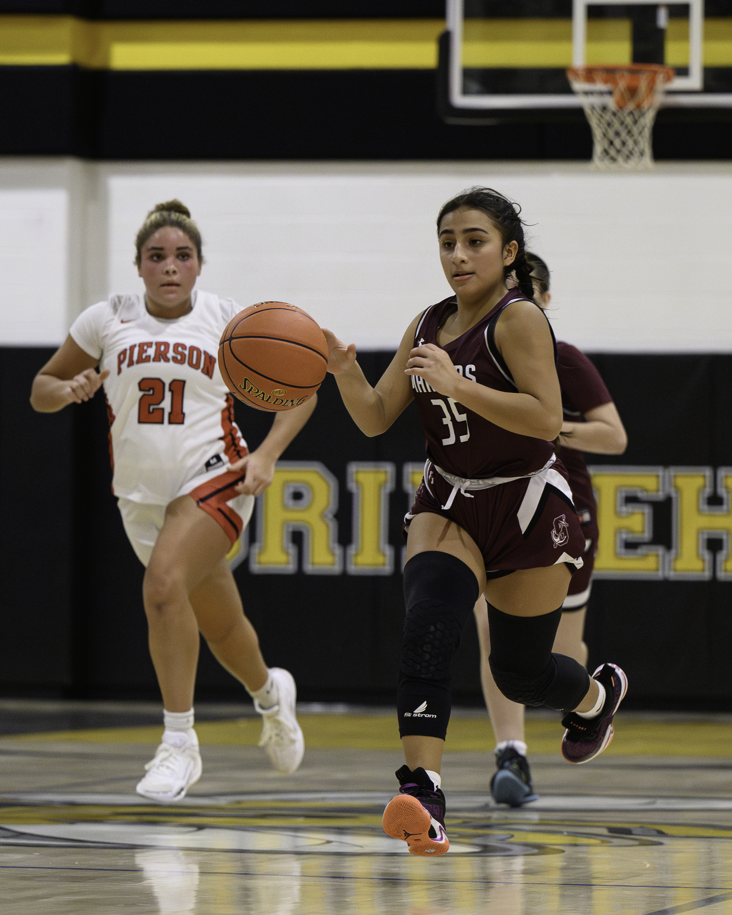Freshman Domenica Davis carries the ball up the court. MARIANNE BARNETT