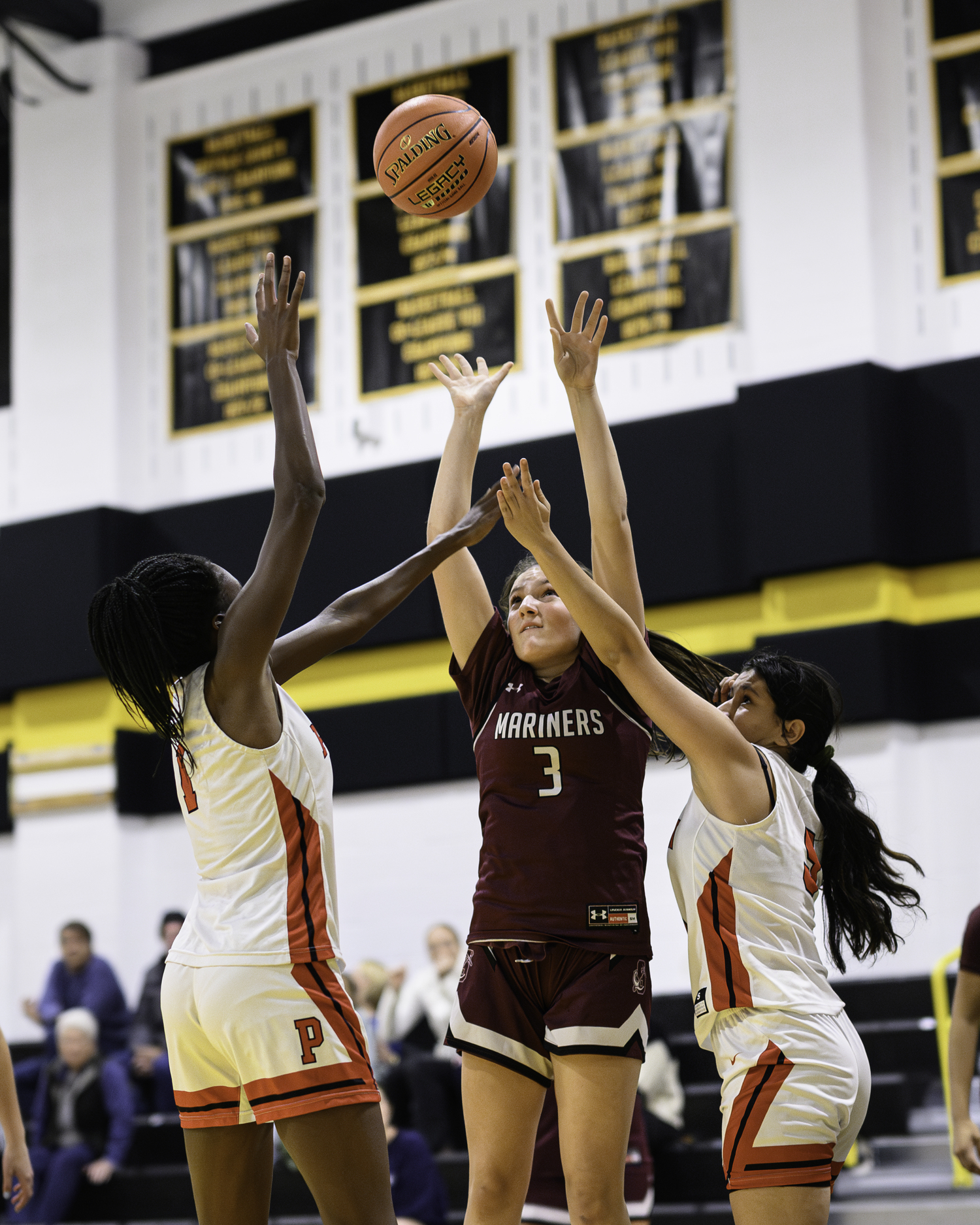 Sophomore Maggie Glanz shoots over block attempts. MARIANNE BARNETT