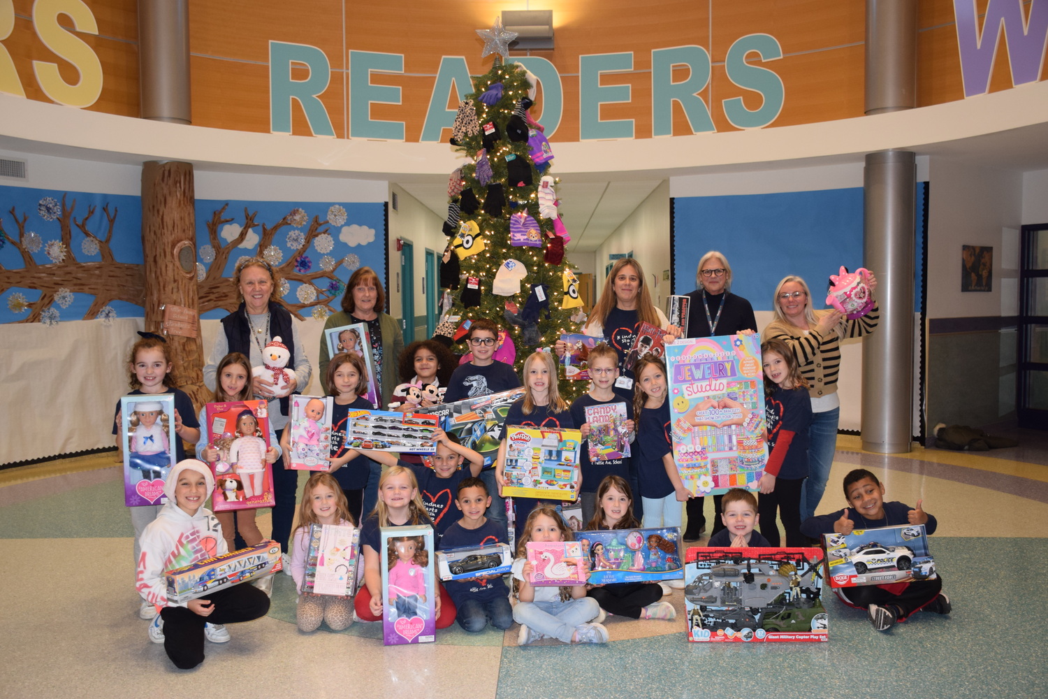 Tuttle Avenue School's Tuttle Cares Club with toys donated by the Suffolk County Police Conference for community children this holiday season. COURTESY EASTPORT-SOUTH MANOR SCHOOL DISTRICT