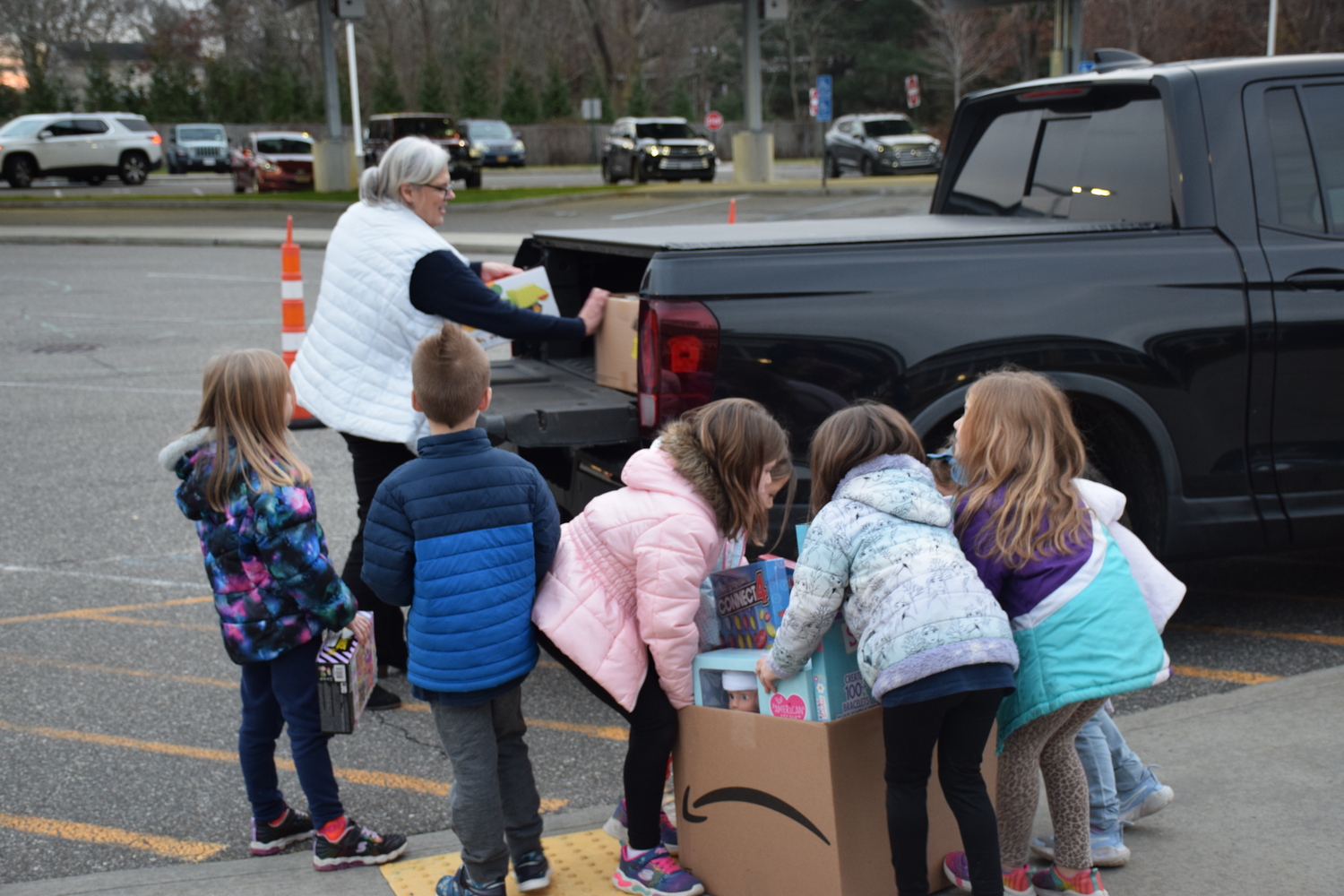 Members of the Tuttle Cares Club helped Parent Child Plus volunteer Lillian Penney loaded up her truck with toy donations for children in the community.  COURTESY EASTPORT-SOUTH MANOR SCHOOL DISTRICT