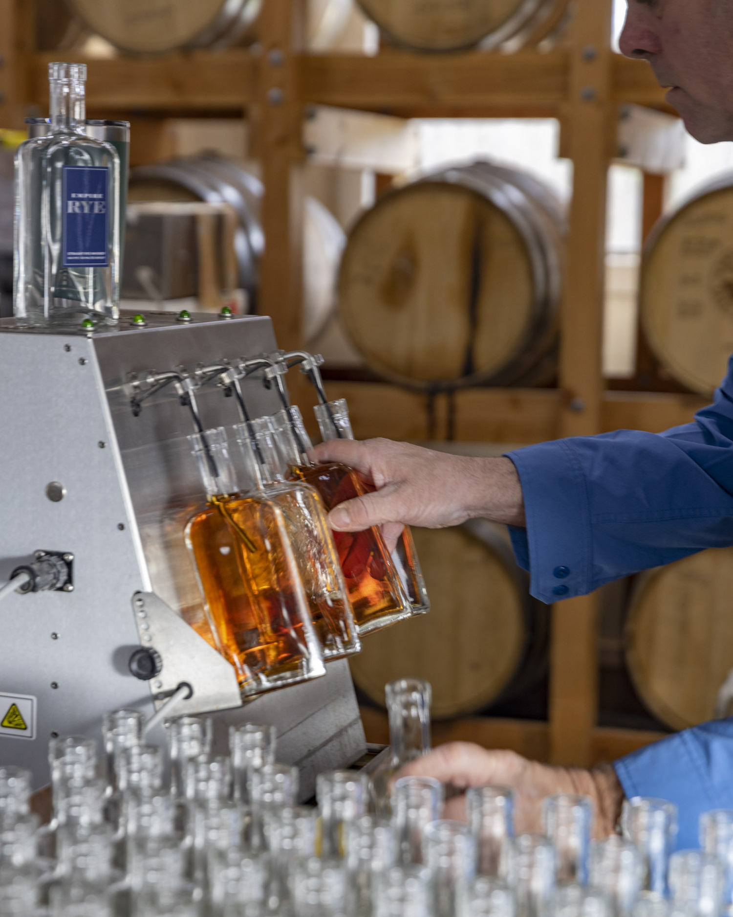 Sagaponack Farm Disillery's head distiller Matt Beamer fills bottles of Empire Rye. JOHN MUSNICKI