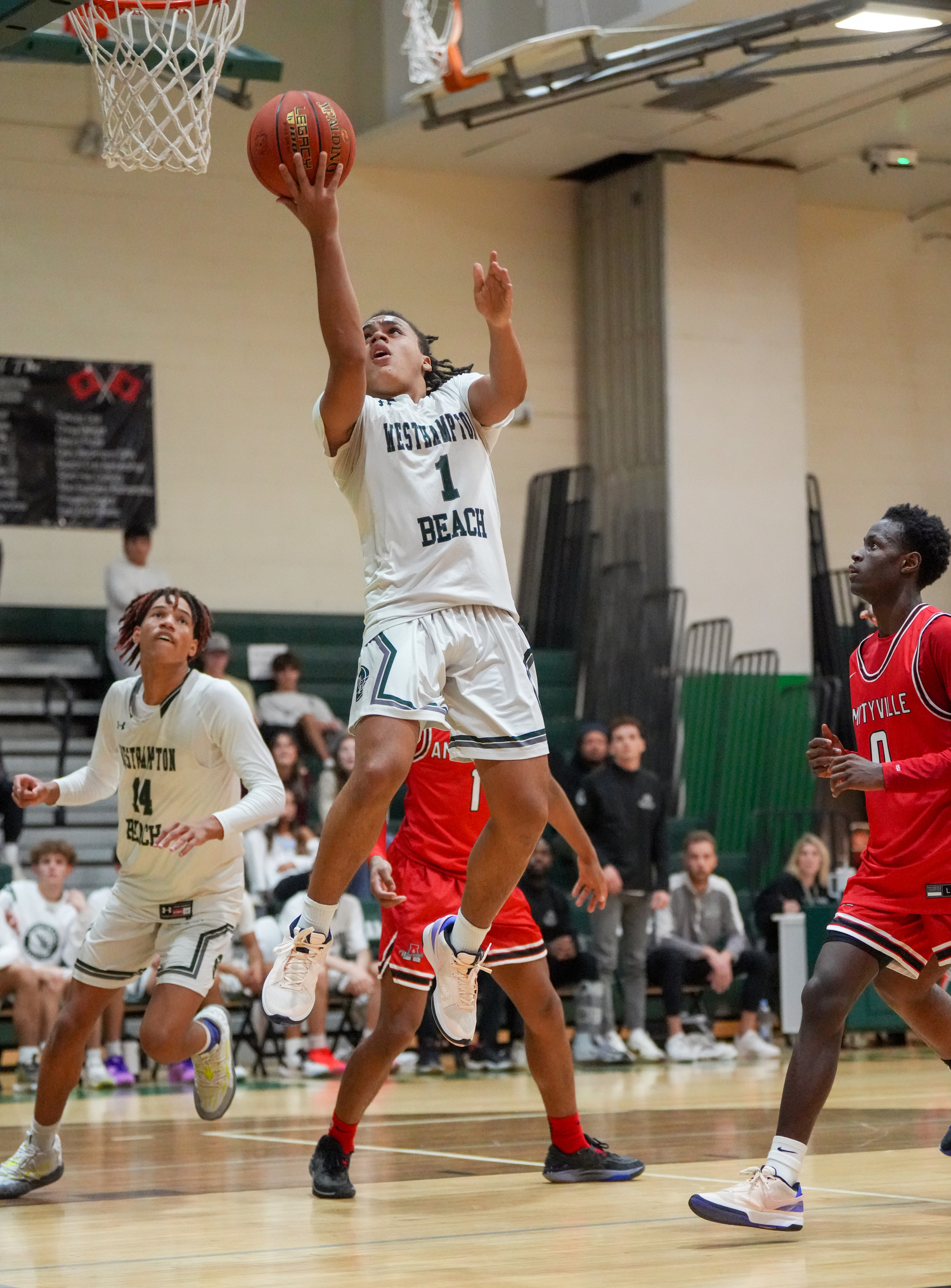 Sophomore point guard Malachi Bullock reaches on a reversal. RON ESPOSITO