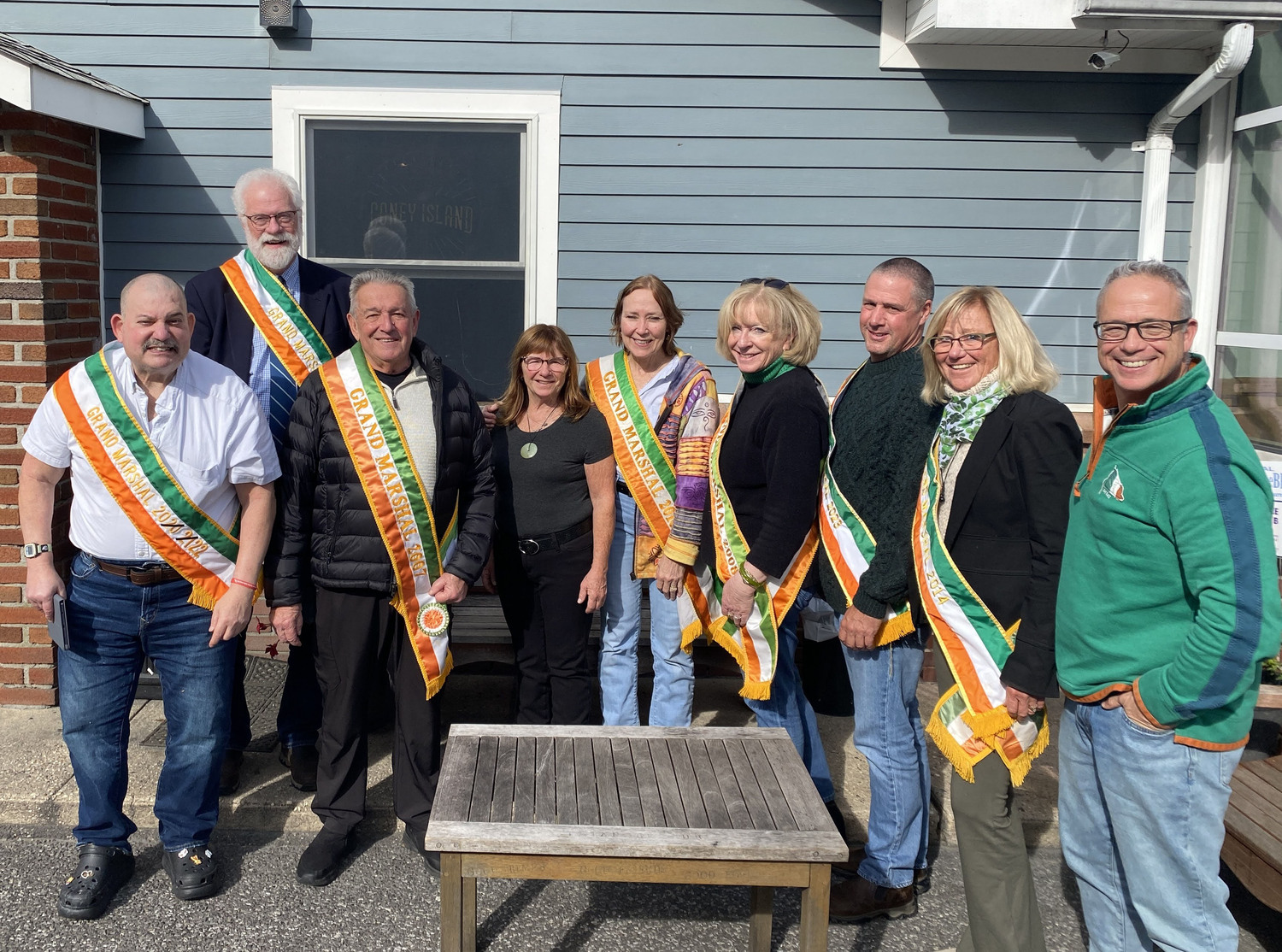 The Westhampton Beach St. Patrick’s Day Parade Committee has announced Patti Ziparo-Dalton as its 56th grand marshal for the 2024 parade. Standing with  Ziparo-Dalton (fourth from left) are past Grand Marshals, from left, Preston Jankowski (2022), Jim Hulme (2017) Bob Strebel (2007) Lynne Jones (2010), Sheryl Heather (2008), Digger Koziarz (2023), Donna Conti (2014) and Committee President Tim Laube. The 55th annual Westhampton Beach St. Patrick’s Day Parade is planned for Saturday, March 9, 2024. COURTESY TIM LAUBE