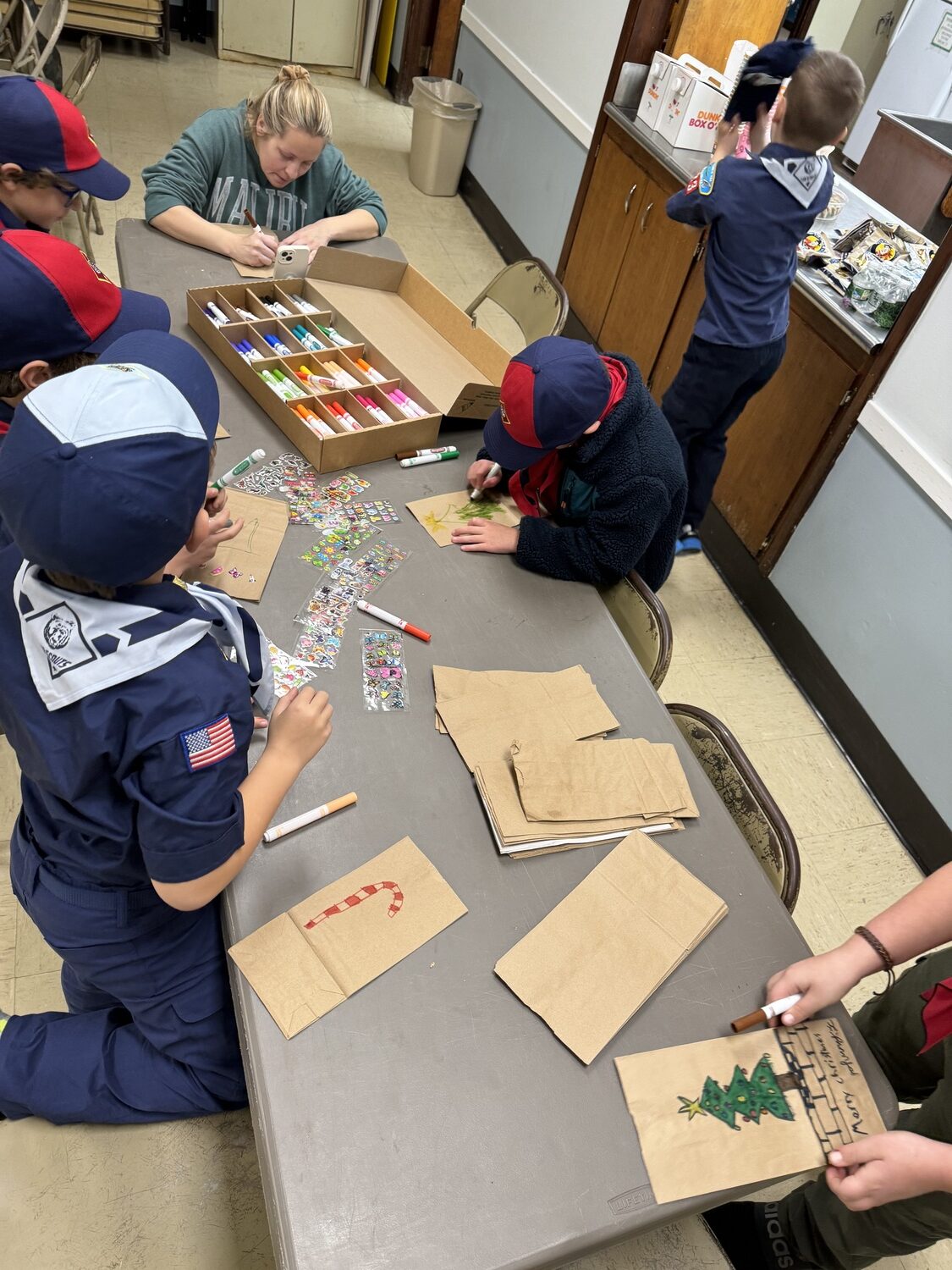 Hampton Bays Pack 483 participated in its annual tradition of making personalized decorated gift bags filled with necessities and treats for the homeless clients of Maureen's Haven. They gathered on December 14 at the Anderson Warner Hall in Hampton Bays to fill the bags with the donated items. COURTESY PACK 483