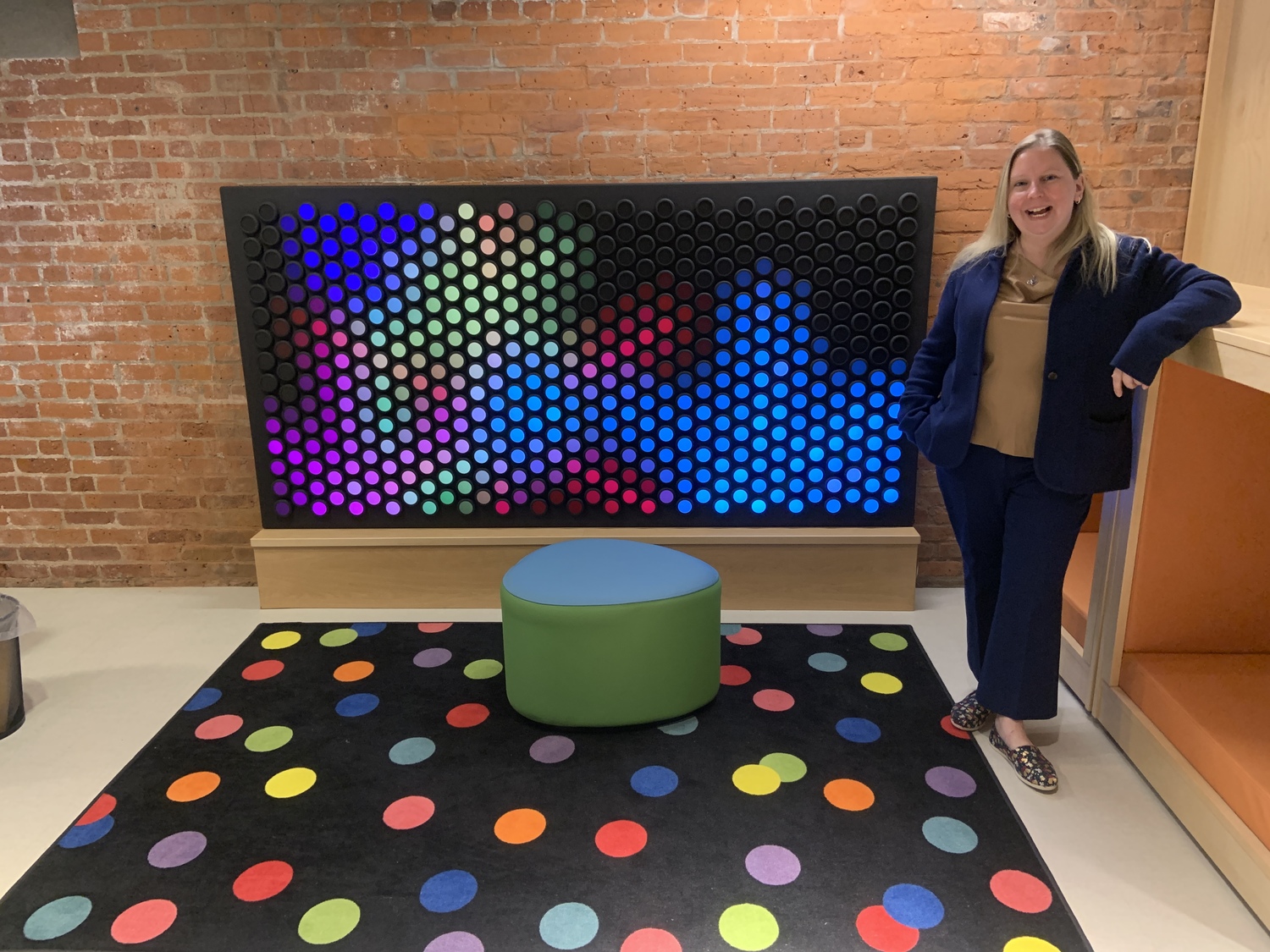 Kelly Harris, the director of the John Jermain Memorial Library, with the new Everbright Board in the newly renovated children's section. STEPHEN J. KOTZ