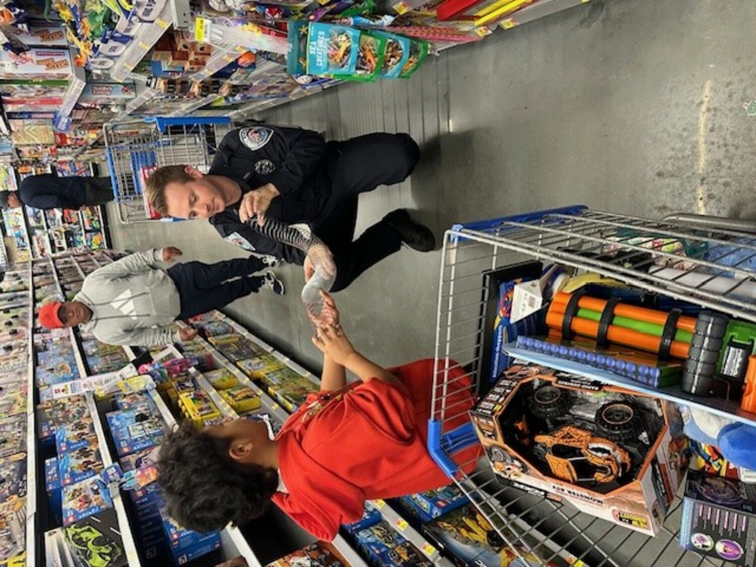 Members of The Southampton Town Police Department, New York  State Troopers, and the Southampton Town Police Explorers participated in a “Shop with a Cop” event  sponsored by Walmart Stores on December 7. The event helps children and families  from Southampton Town spread holiday cheer  and officers shared dinner with the families before  shopping at Walmart. Walmart in Riverhead provided a significant donation, along with Southampton  Town Patrolman’s Benevolent Association, and Southampton Town Superior Officer’s Association.  COURTESY SOUTHAMPTON TOWN POLICE DEPARTMENT