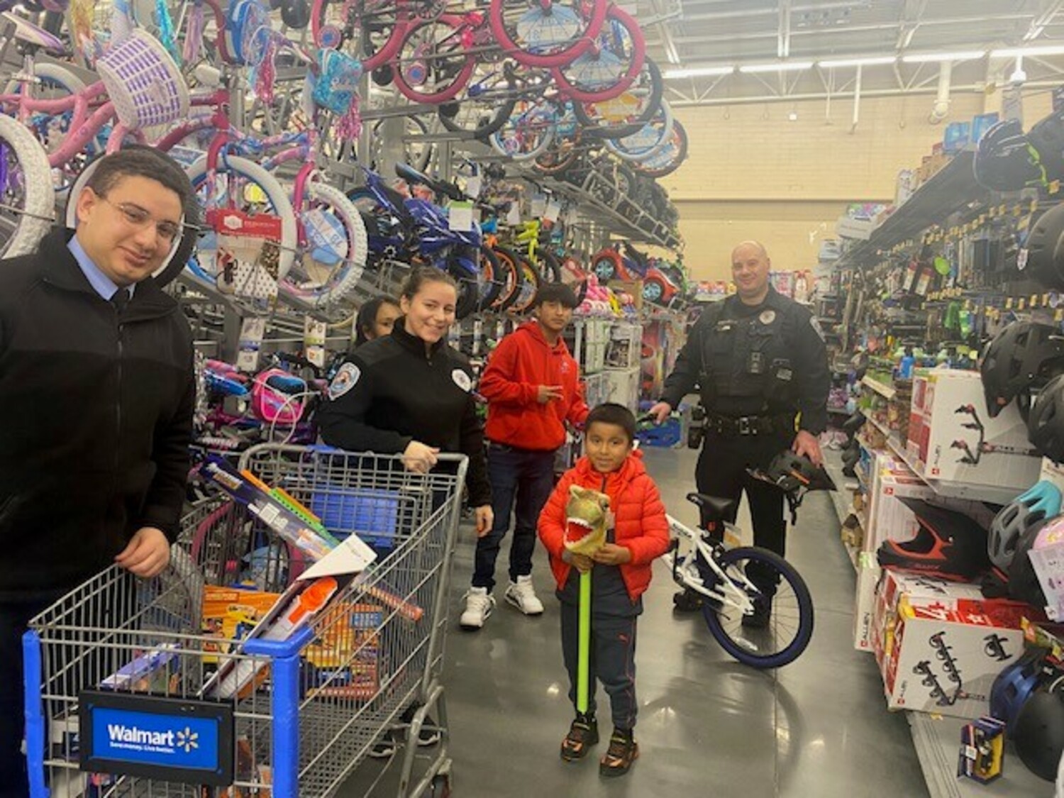 Members of The Southampton Town Police Department, New York  State Troopers, and the Southampton Town Police Explorers participated in a “Shop with a Cop” event  sponsored by Walmart Stores on December 7. The event helps children and families  from Southampton Town spread holiday cheer  and officers shared dinner with the families before  shopping at Walmart. Walmart in Riverhead provided a significant donation, along with Southampton  Town Patrolman’s Benevolent Association, and Southampton Town Superior Officer’s Association.  COURTESY SOUTHAMPTON TOWN POLICE DEPARTMENT