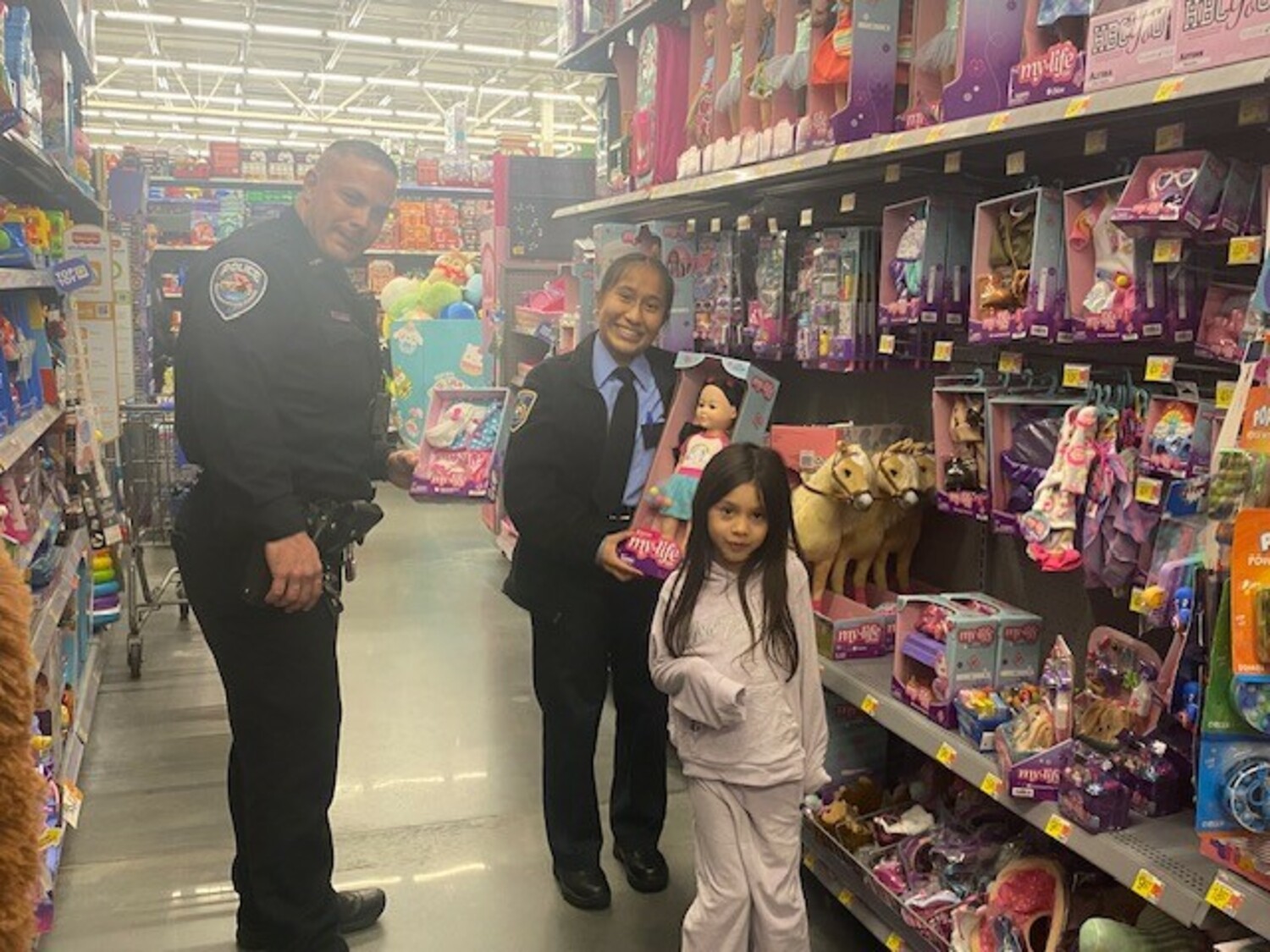 Members of The Southampton Town Police Department, New York  State Troopers, and the Southampton Town Police Explorers participated in a “Shop with a Cop” event  sponsored by Walmart Stores on December 7. The event helps children and families  from Southampton Town spread holiday cheer  and officers shared dinner with the families before  shopping at Walmart. Walmart in Riverhead provided a significant donation, along with Southampton  Town Patrolman’s Benevolent Association, and Southampton Town Superior Officer’s Association.  COURTESY SOUTHAMPTON TOWN POLICE DEPARTMENT