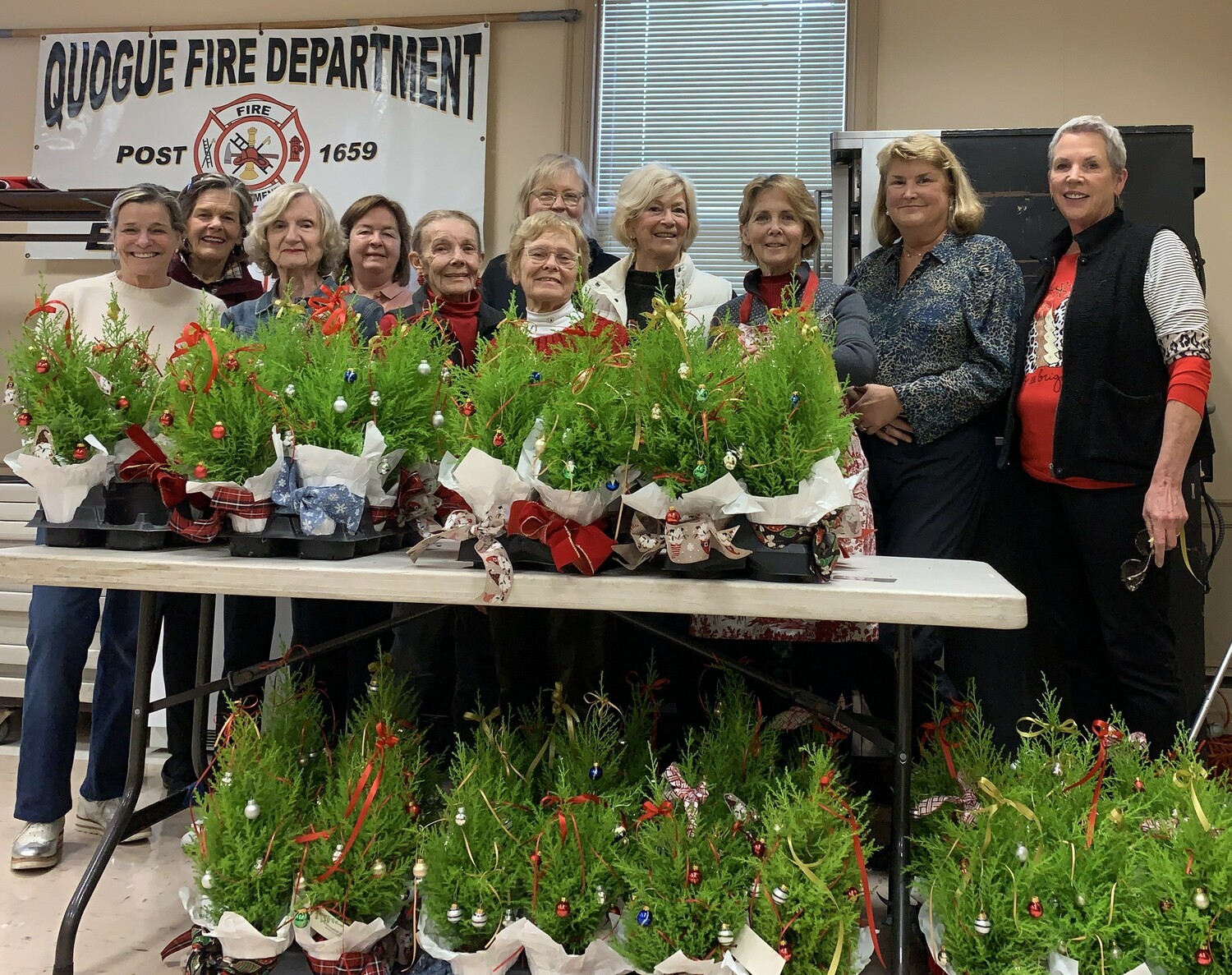 Westhampton Garden Club members gathered with Chair Barbara Sartorius, third from right, at the Quogue Firehouse for the club's annual topiary decorating workshop..  The ornamental mini-shrubs will be distributed to East End Hospice patients throughout the area and at the Kanas Center for Hospice Care in Westhampton for the holiday season. COURTESY WESTHAMPTON GARDEN CLUB