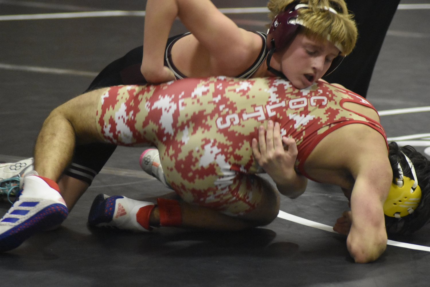 East Hampton's Caleb Mott defeated his Hills West opponent to stay alive in the wrestlebacks.   DREW BUDD