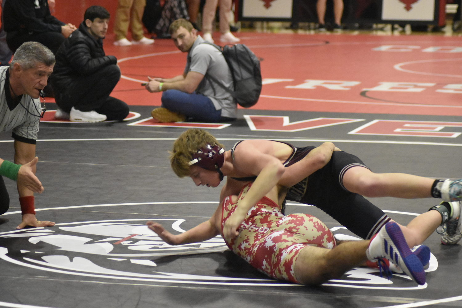 East Hampton's Caleb Mott defeated his Hills West opponent to stay alive in the wrestlebacks.   DREW BUDD
