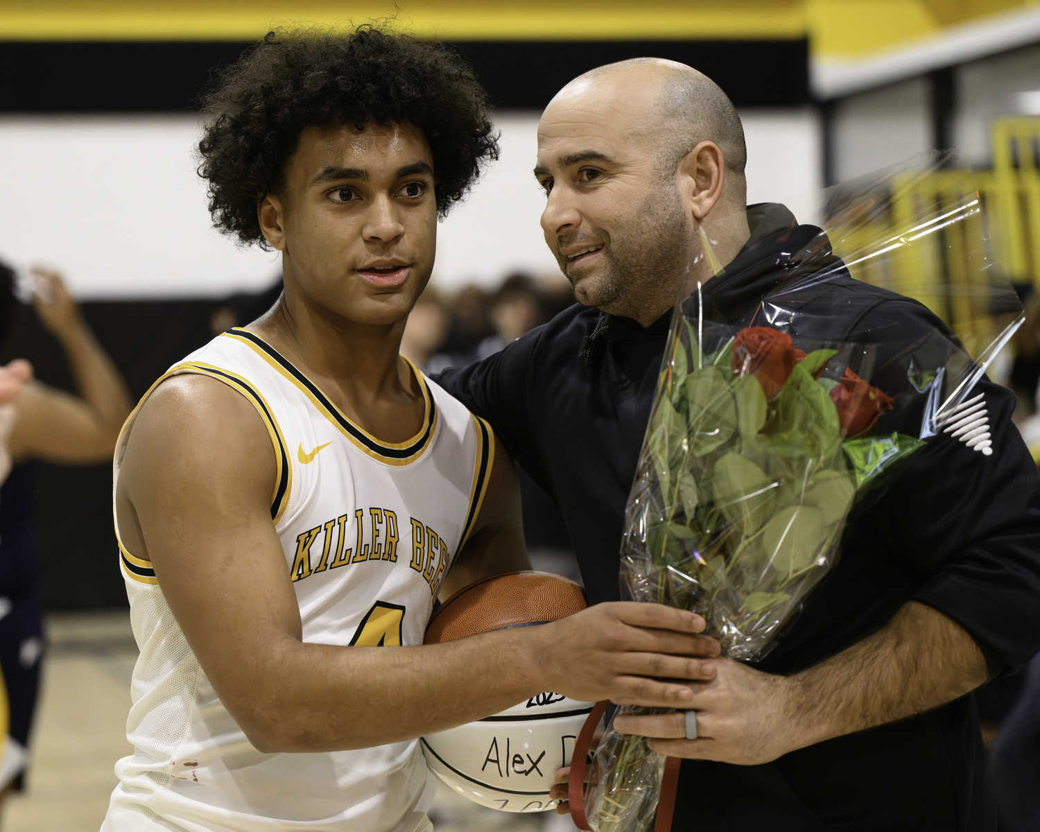 Bridgehampton Athletic Director Michael DeRosa hands a bouquet of flowers to Alex Davis to give his mother Kelley.   MARIANNE BARNETT