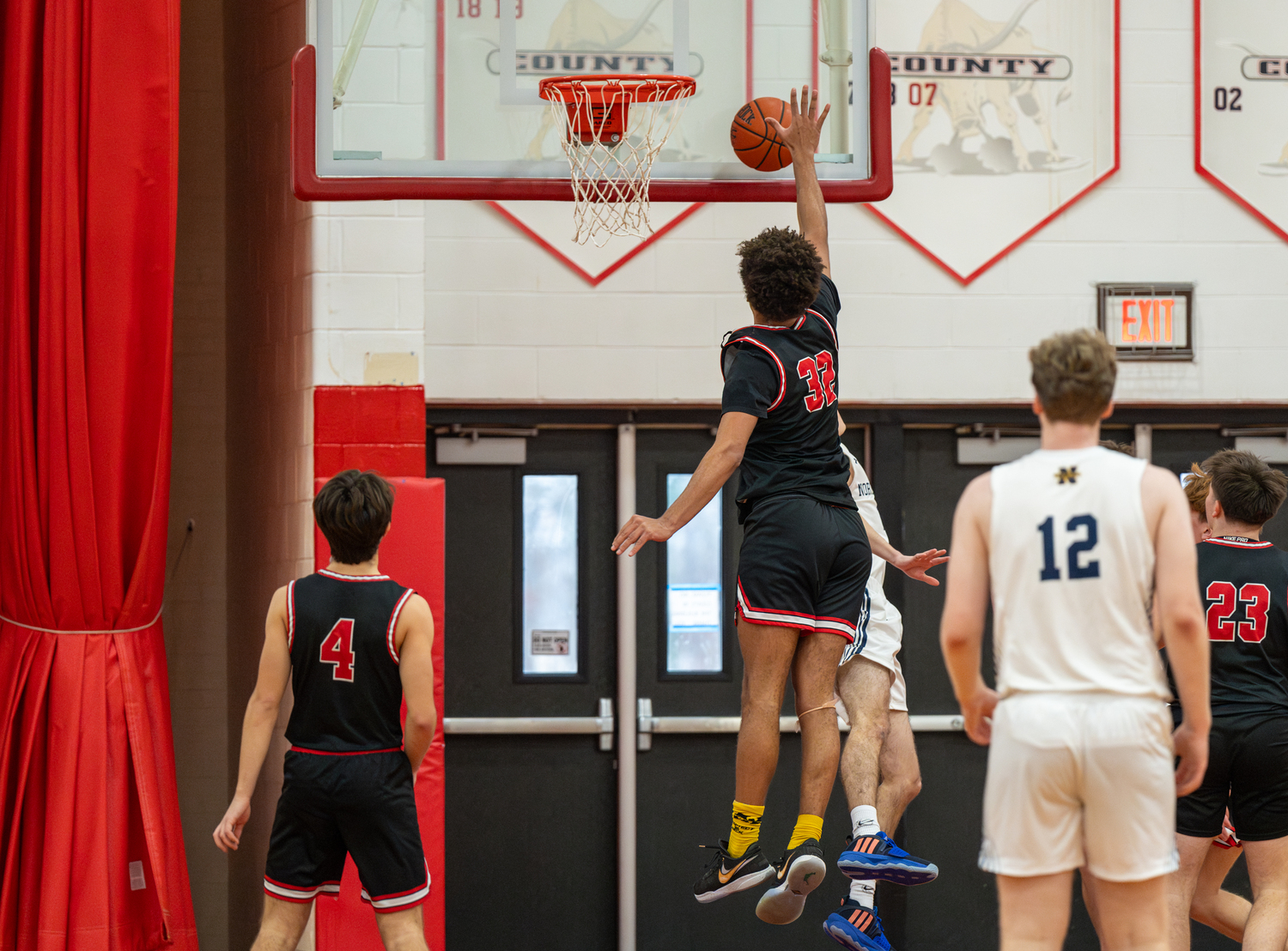 Pierson senior Charlie McLean claps a shot off the backboard for a block.   RON ESPOSITO