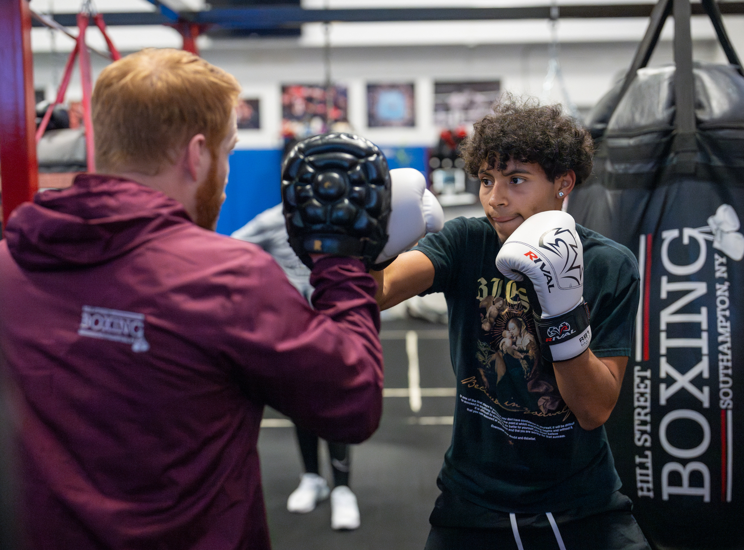 Southampton High School senior Chris Atancuri practices with Avery Crocker as part of the district's boxing club. RON ESPOSITO