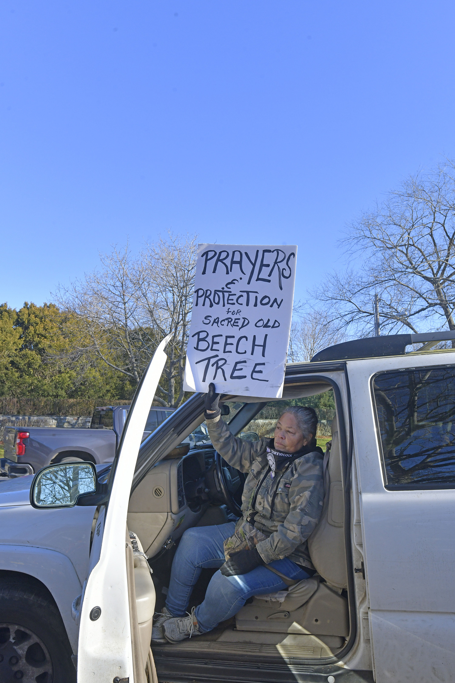 Becky Genia of the Shinnecock Nation  at the large, old beech tree at the corner of East Gate Road and Hill Street on Monday. DANA SHAW