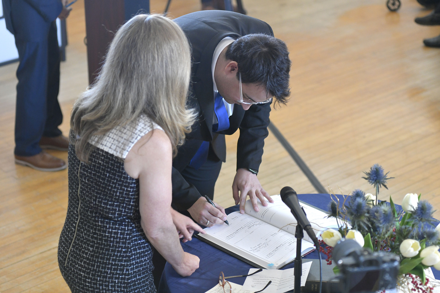 Michael Iasilli signs the book after being sworn in as Southampton Town Councilman on Janurary 3.  DANA SHAW